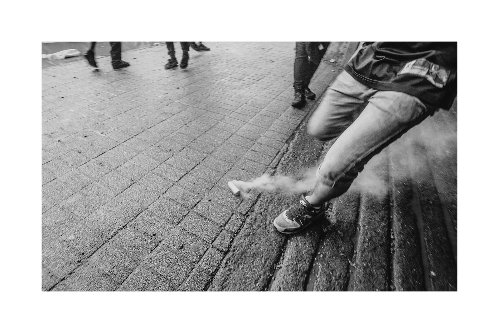 © Matias Cortez - man kicking out a tear bomb gas