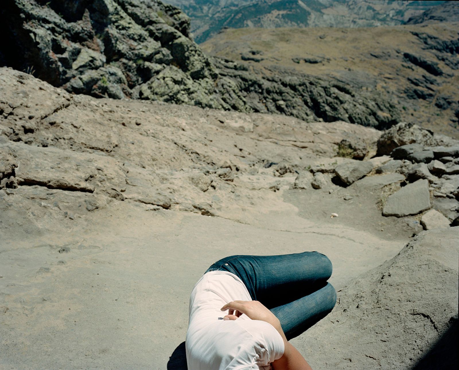 © Miriam Stanke - Woman lying on the holy rocks of Düzgün Baba, which are said to heal back pains.