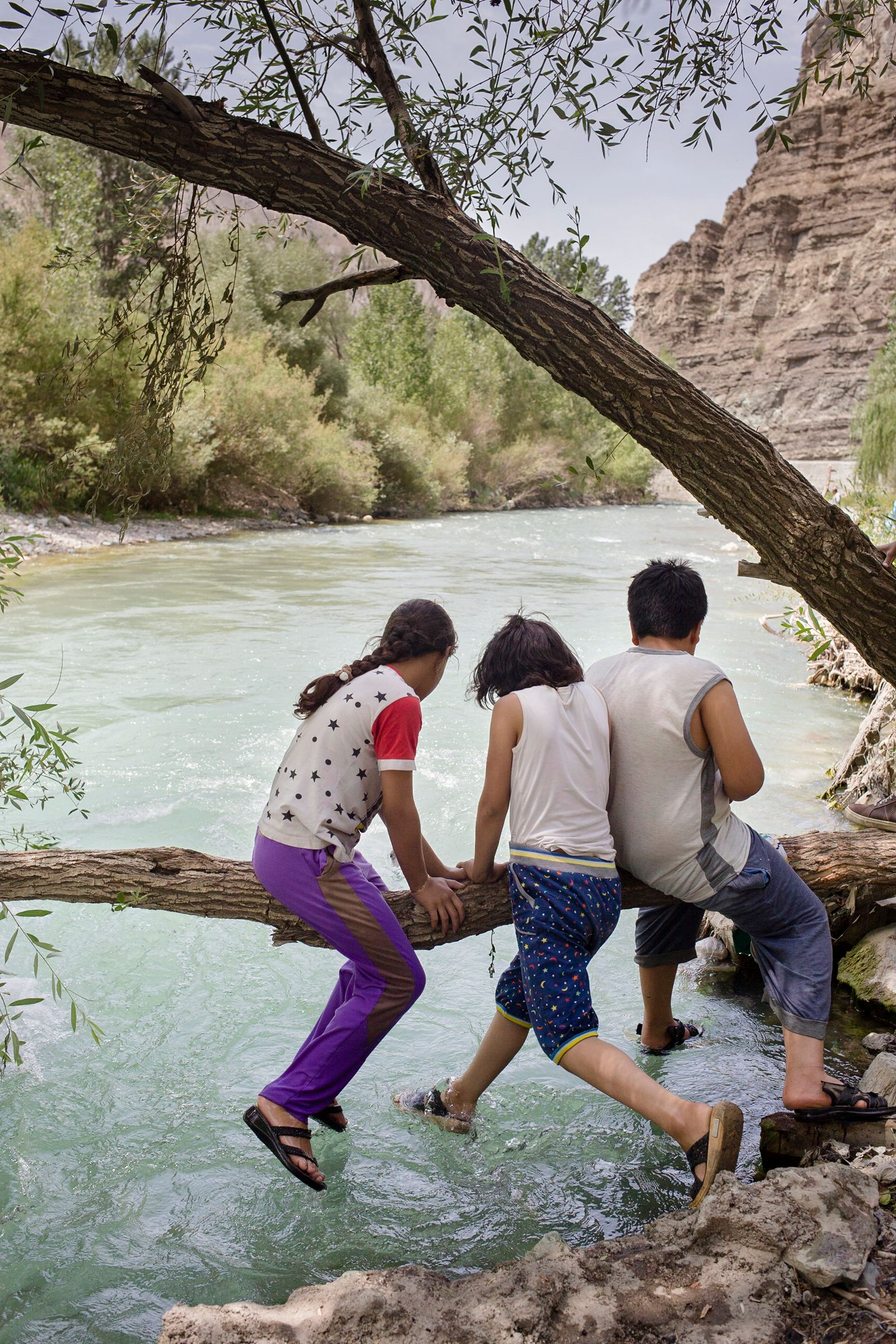 © Parisa Azadi - JULY 24, 2018 - Children play in the river along Chalus road on a hot summer day in Mazandaran Province, Iran.