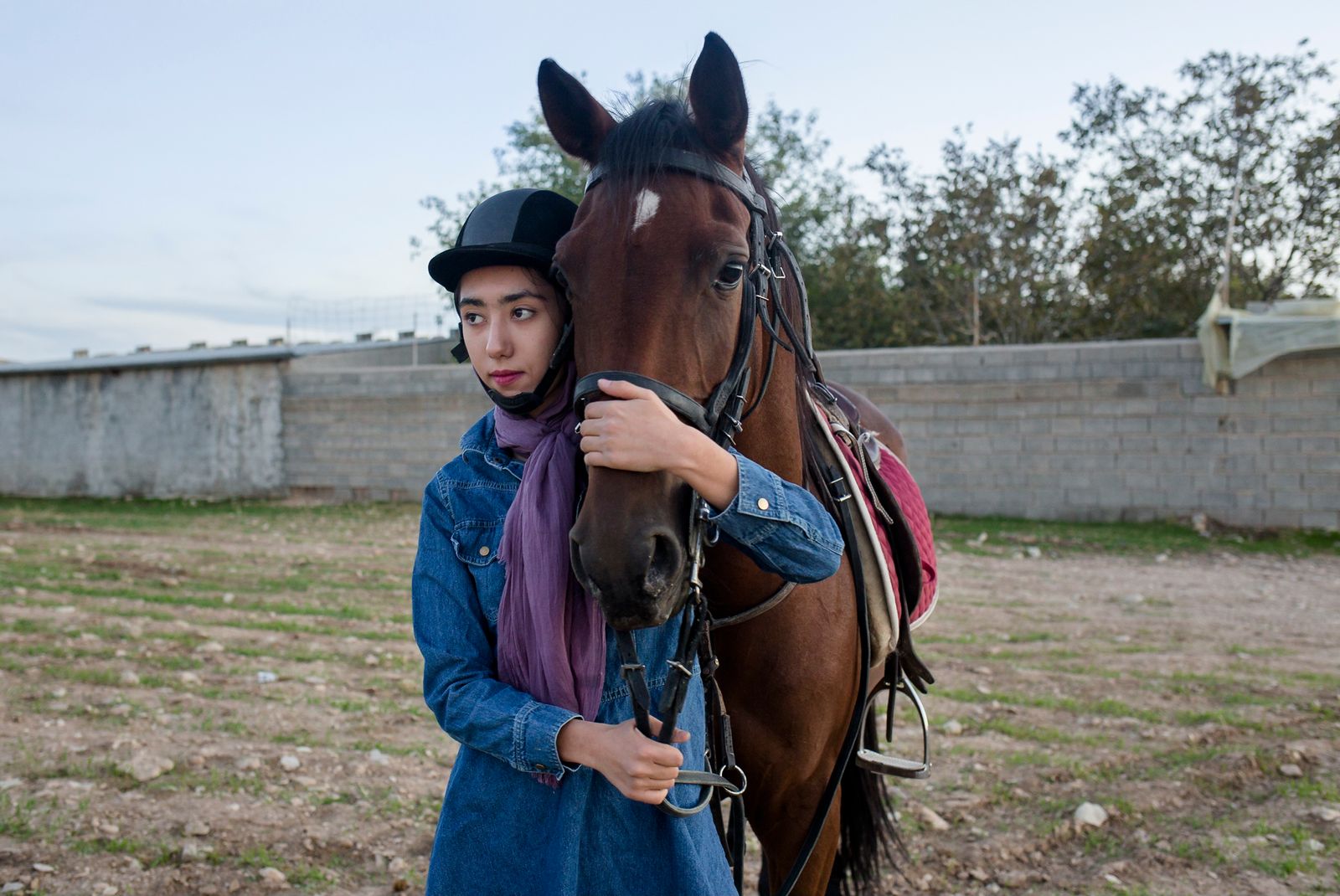 © Parisa Azadi - NOVEMBER 1, 2018 - Kimia Sorkhehmiri takes a break during a horse riding lesson in Ilam, Iran.