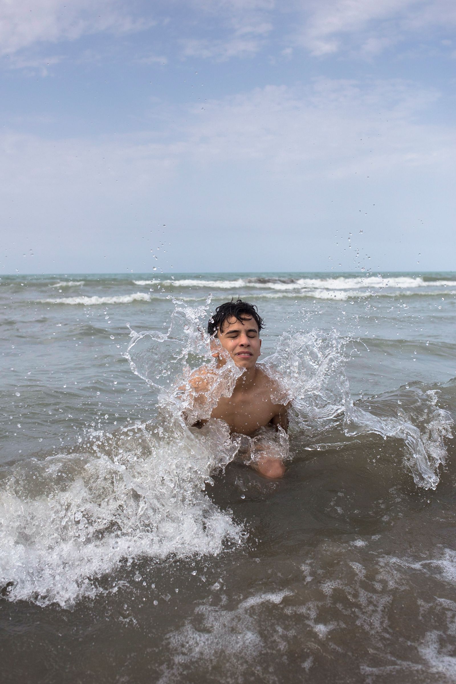 © Parisa Azadi - JULY 26, 2018 - An Iraqi tourist swims in the Caspian Sea in Chalus, Iran.