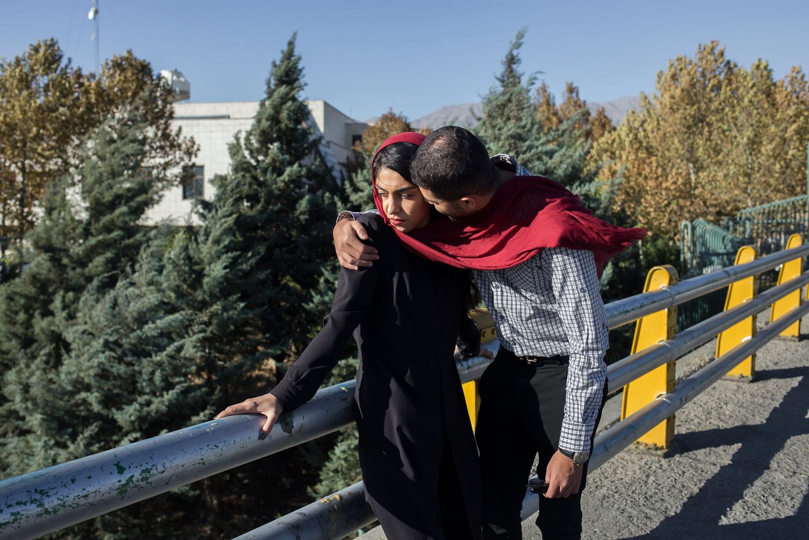 © Parisa Azadi - OCTOBER 13, 2017 - Negar and her friend Hussain embrace each other on the streets of Tehran, Iran.