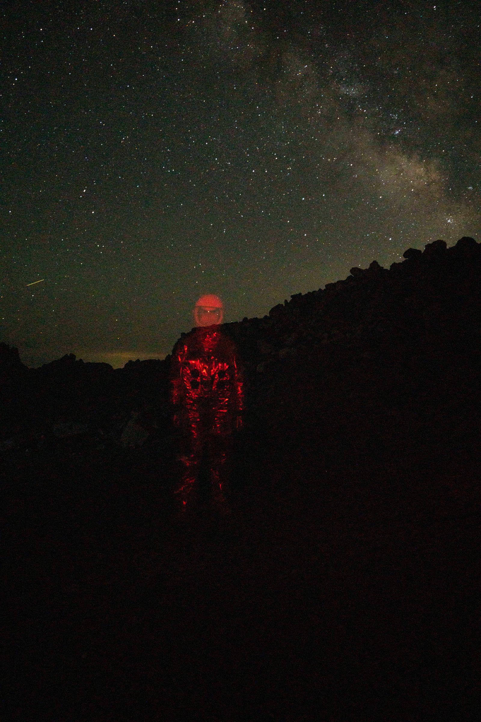 © Mackenzie Calle - A queer person, semi-erased from the world while in an astronaut suit.