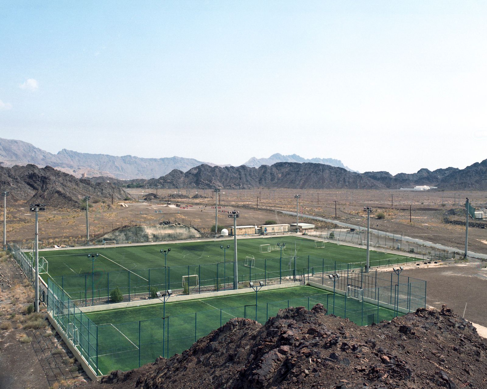 © VALENTIN JOSEPH VALETTE - A new soccer field was built on the outskirts of the city and surrounded by mountains. Nizwa, October 2021.
