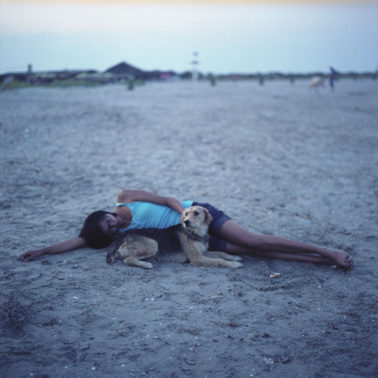 © Chiara Fossati - Jesse, 19 years old, and a stray dog on the beach of Sulina, Romania.