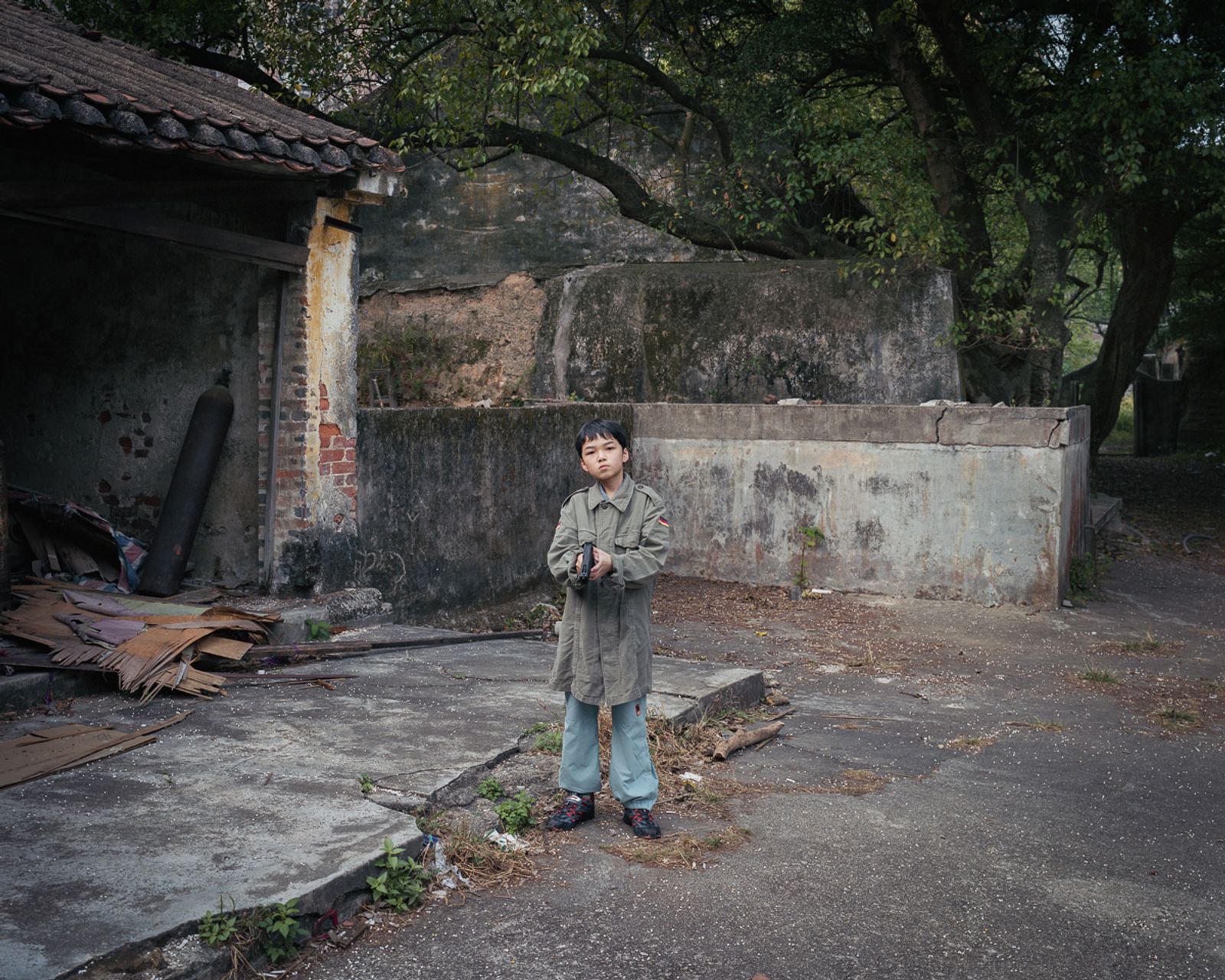 © Adam Lampton - Boy with a Toy Gun, Macao (Img#: 16) (Size: 28x30") Archival Inkjet Print (2007/18)