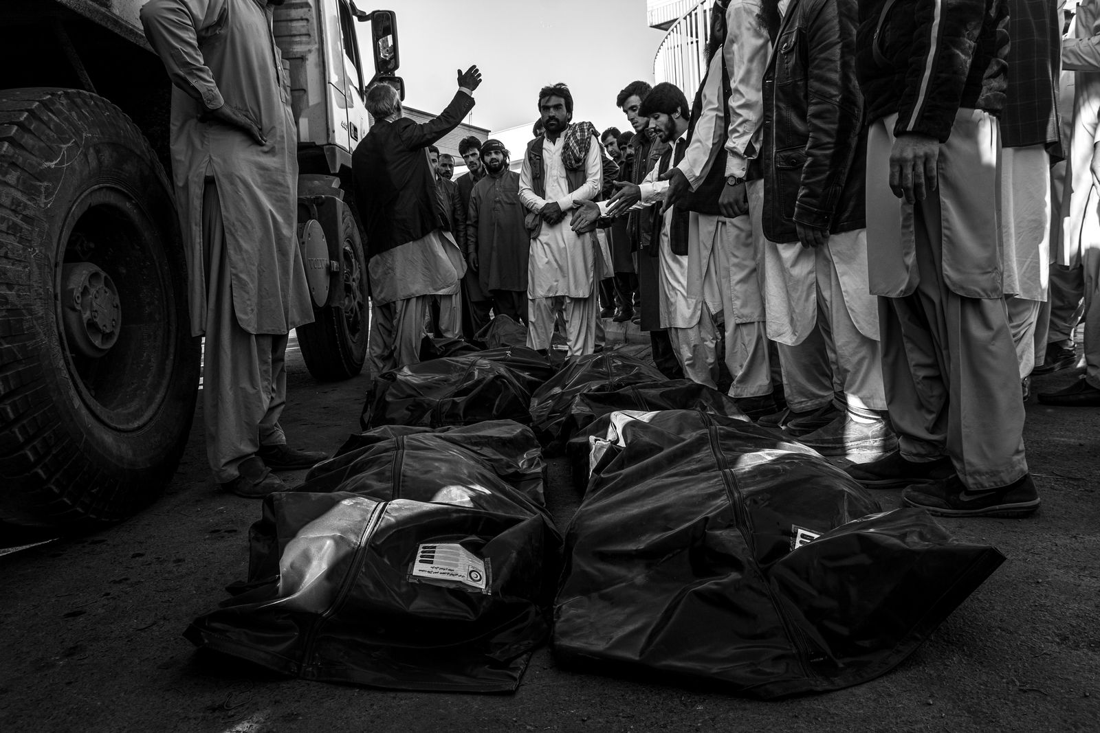 © Zobair Movahhed - Local Iranian people pray over the bodies of Afghan refugees who died in a car accident.