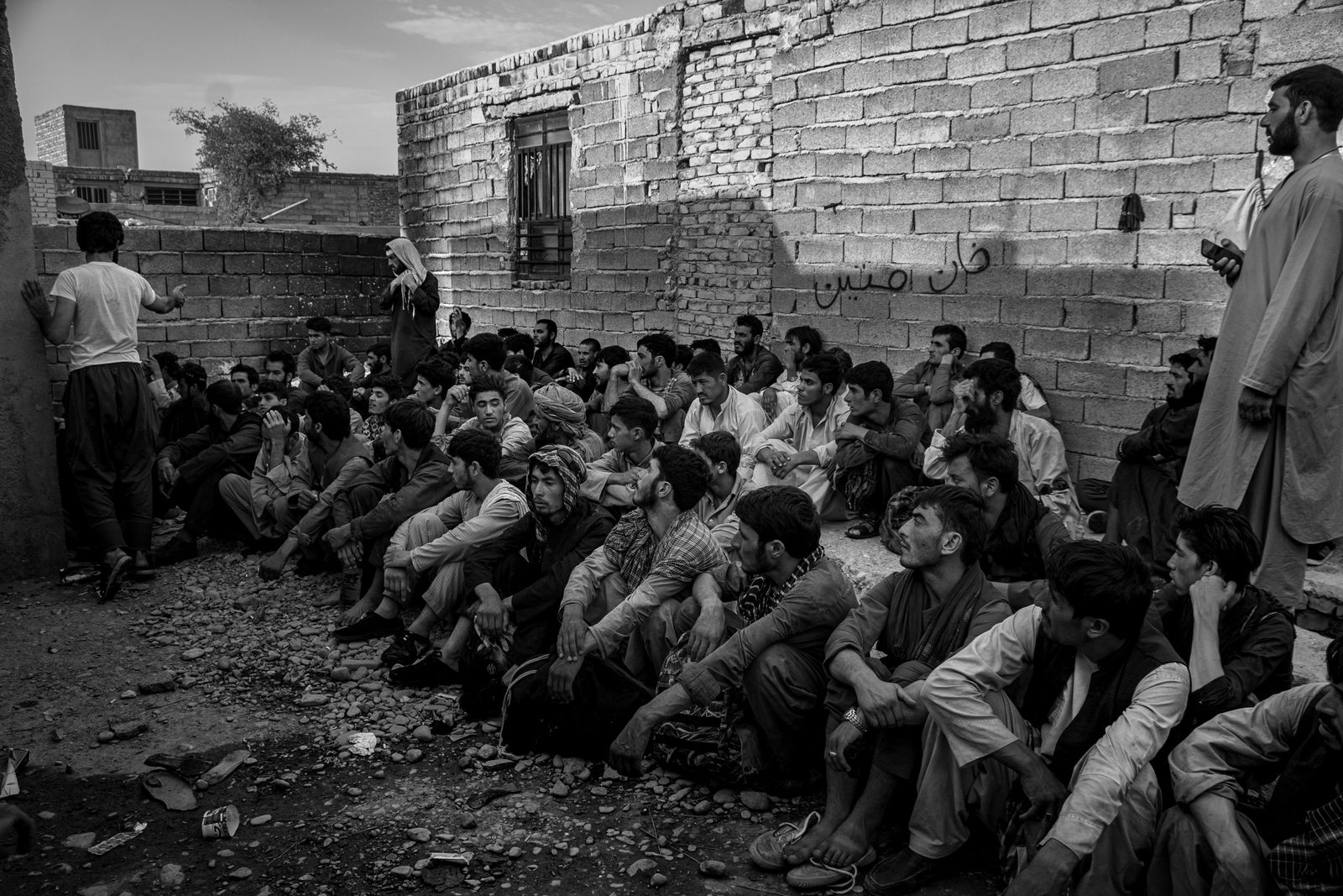 © Zobair Movahhed - Afghan refugees, after having recently crossed the border into Iran, wait to be transported to their next destination.