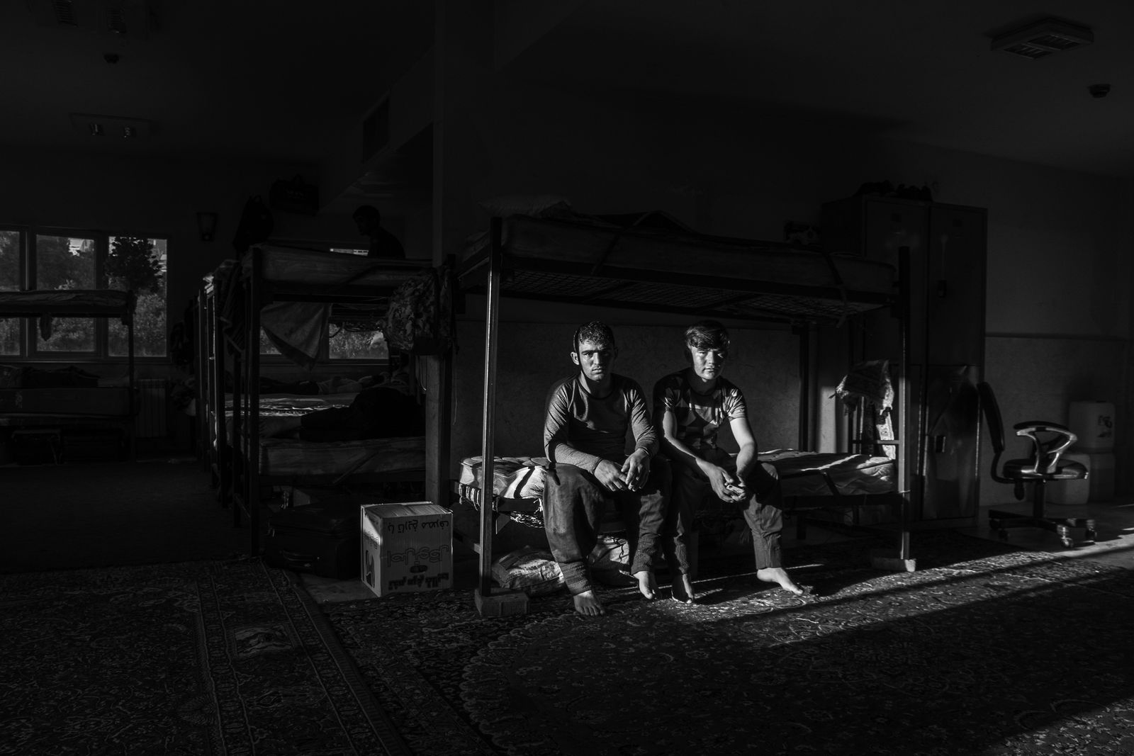 © Zobair Movahhed - Afghan refugee workers, who have been hired as sanitation workers, rest in their dormitory in Tehran, Iran.