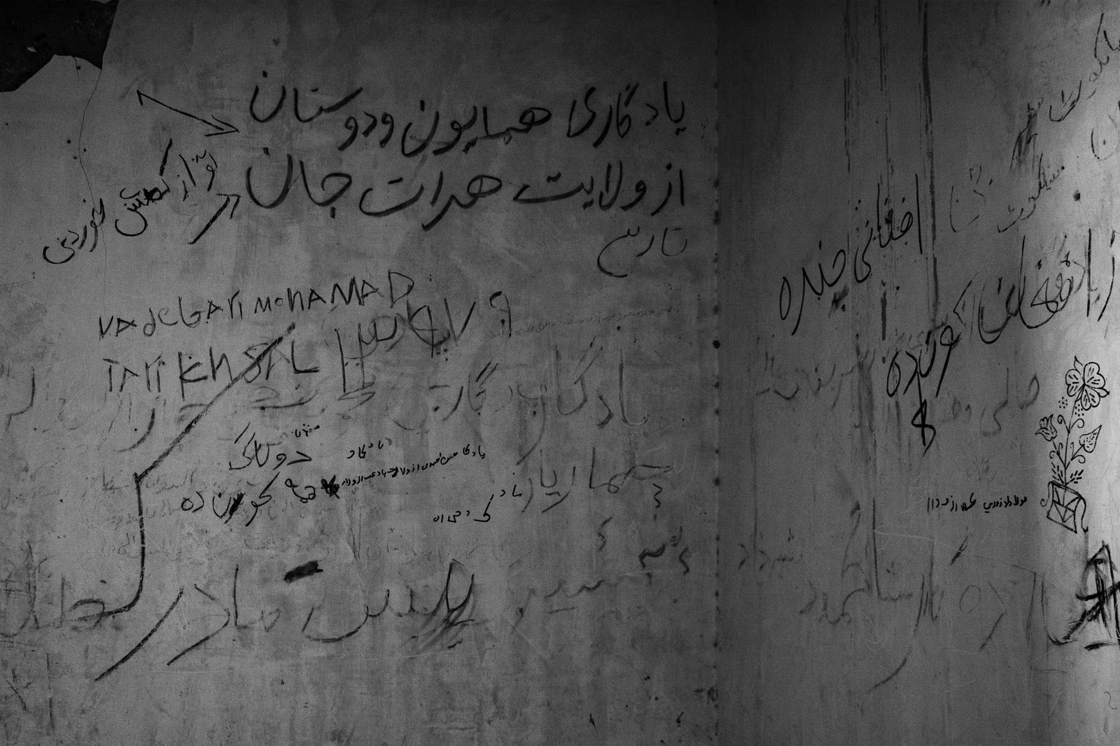 © Zobair Movahhed - Graffiti adorns the walls of a room on the Afghanistan-Iranian border, scrawled by Afghan refugees.