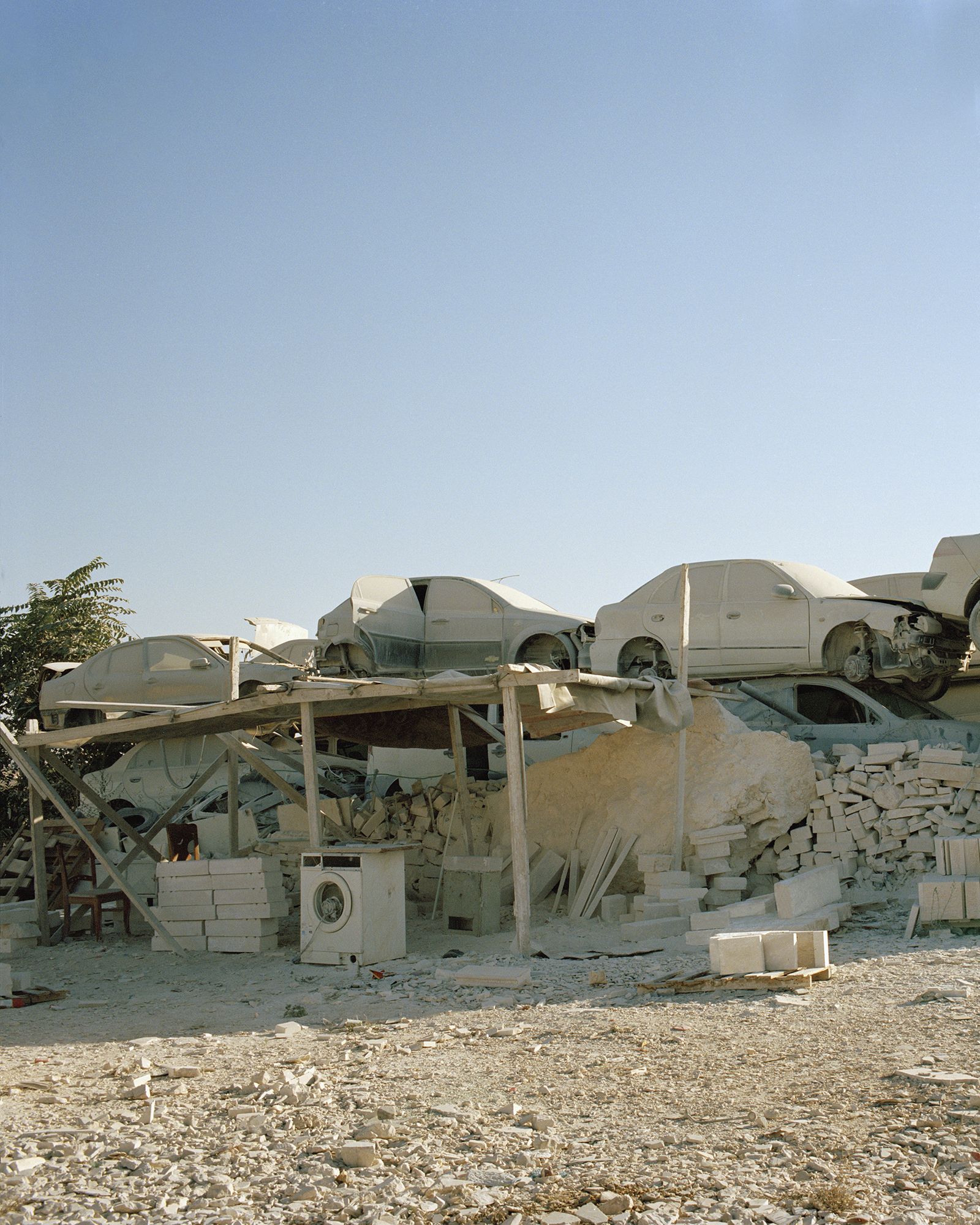 © Saja Quttaineh - Car graveyard and some discarded things all covered in dust in Kalndia neighborhood, Jerusalem city, 2021.