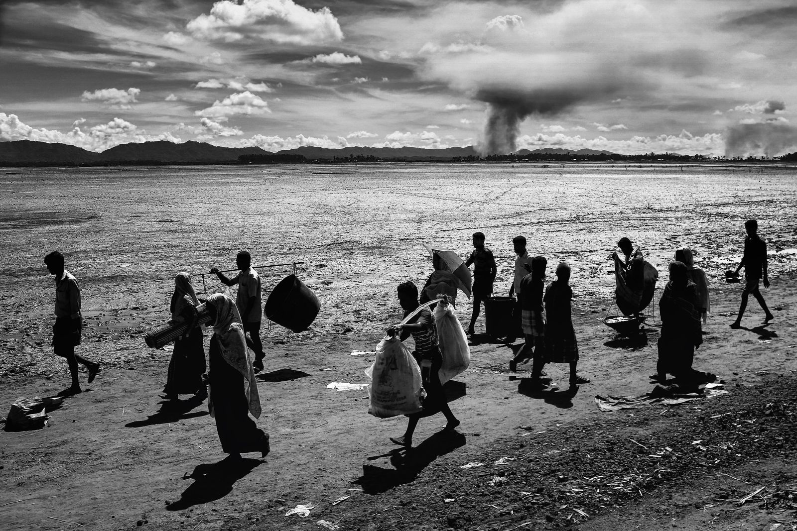 © Mohammad Rakibul Hasan - Rohingya refugees are entering Bangladesh while empty houses in the villages in Myanmar have been set fire by Army.