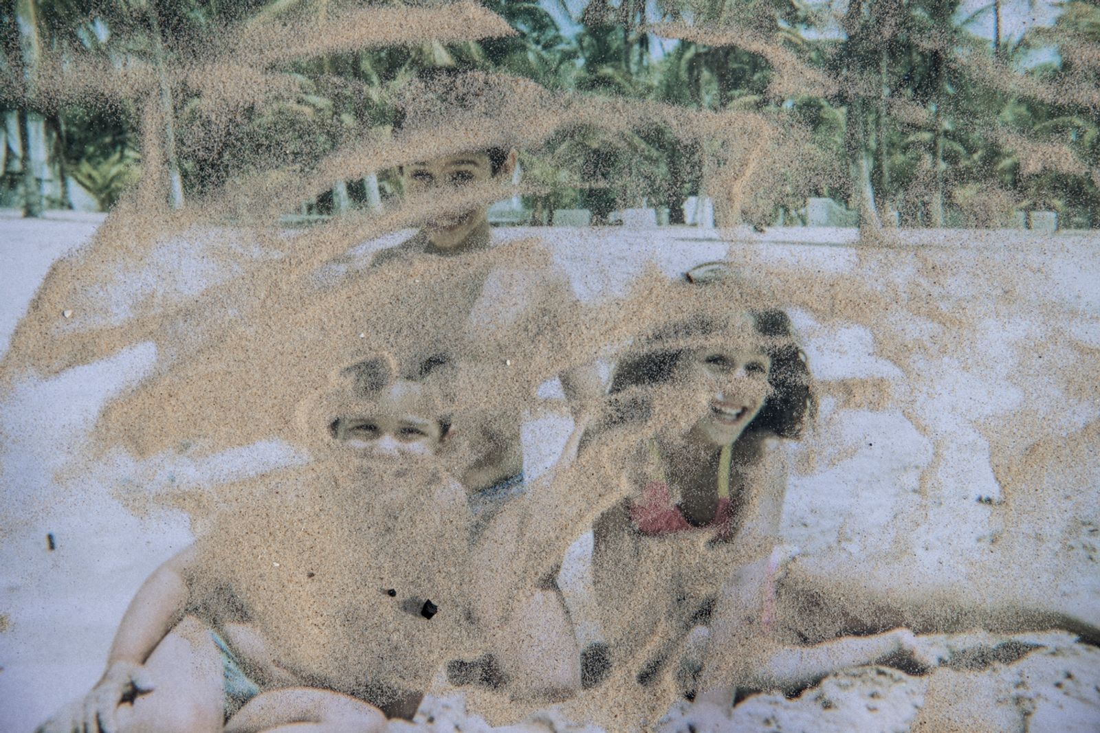 © Fabiola Ferrero - An old image of me and my brothers intervened with sand of the same beach where it was taken, Machurucuto, in Venezuela.