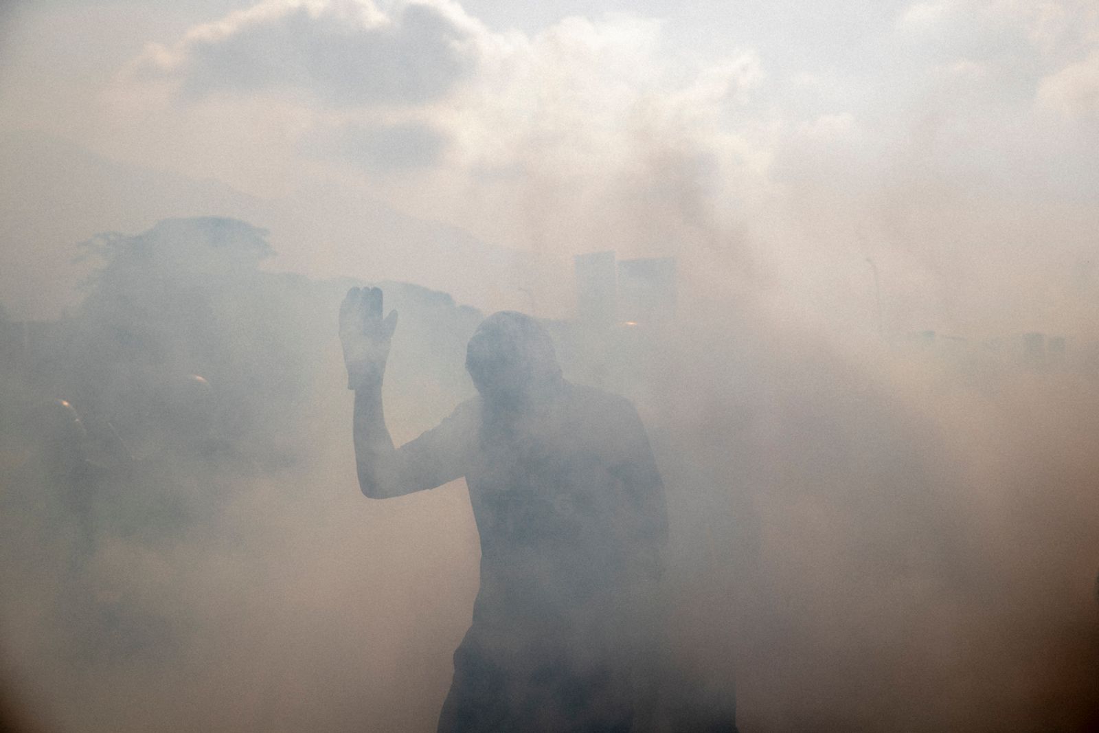 © Fabiola Ferrero - A man in the middle of tear gas during a military uprising in Caracas on April 30, 2019.