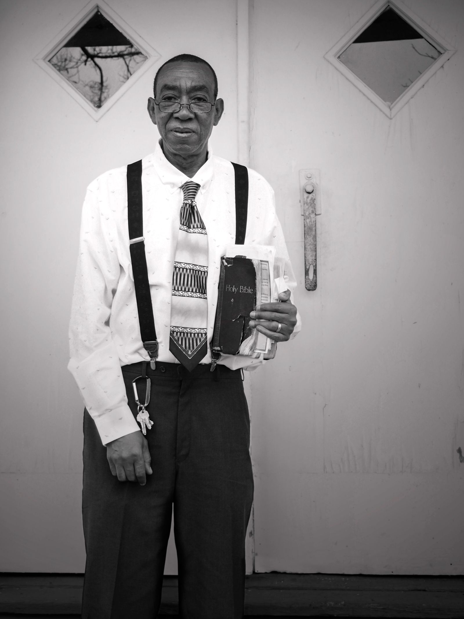 © Rebecca Moseman - Preacher Man. Mr. Hoover, the local preacher of the Mt. Zion church stand outside the church doors after the Sunday service.