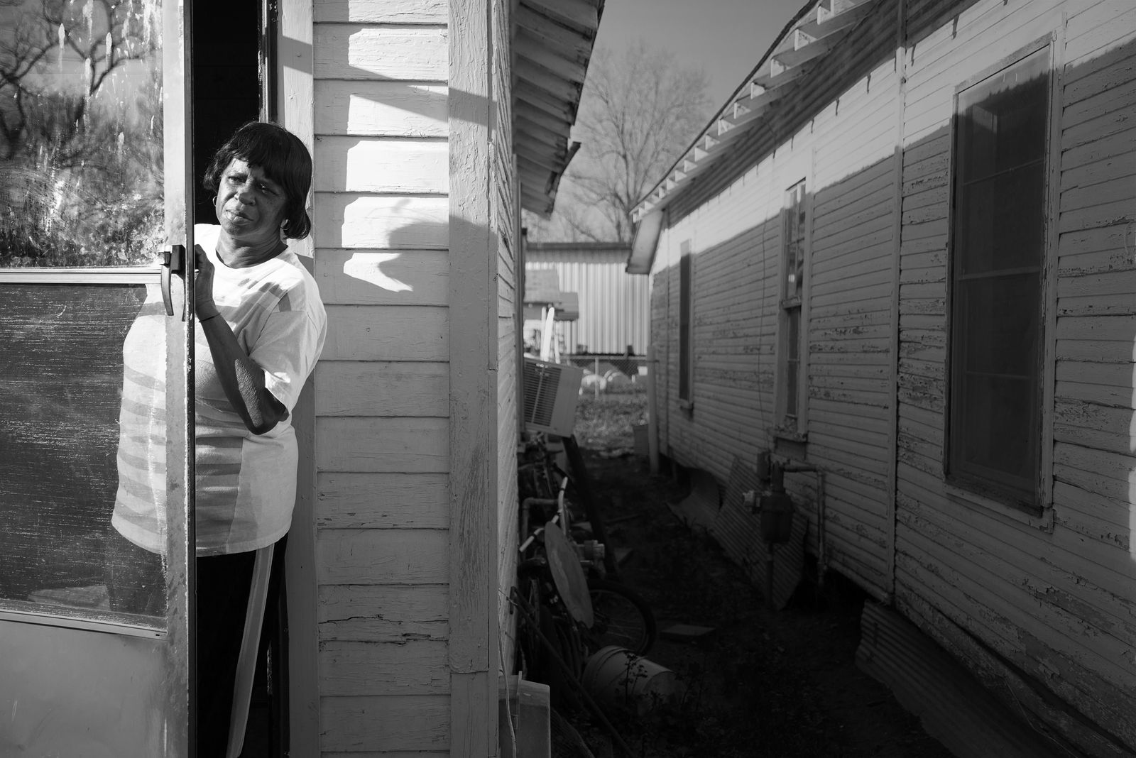 © Rebecca Moseman - Concerned Mother. A mother from Baptist Town, Mississippi checks on her children playing on the street.