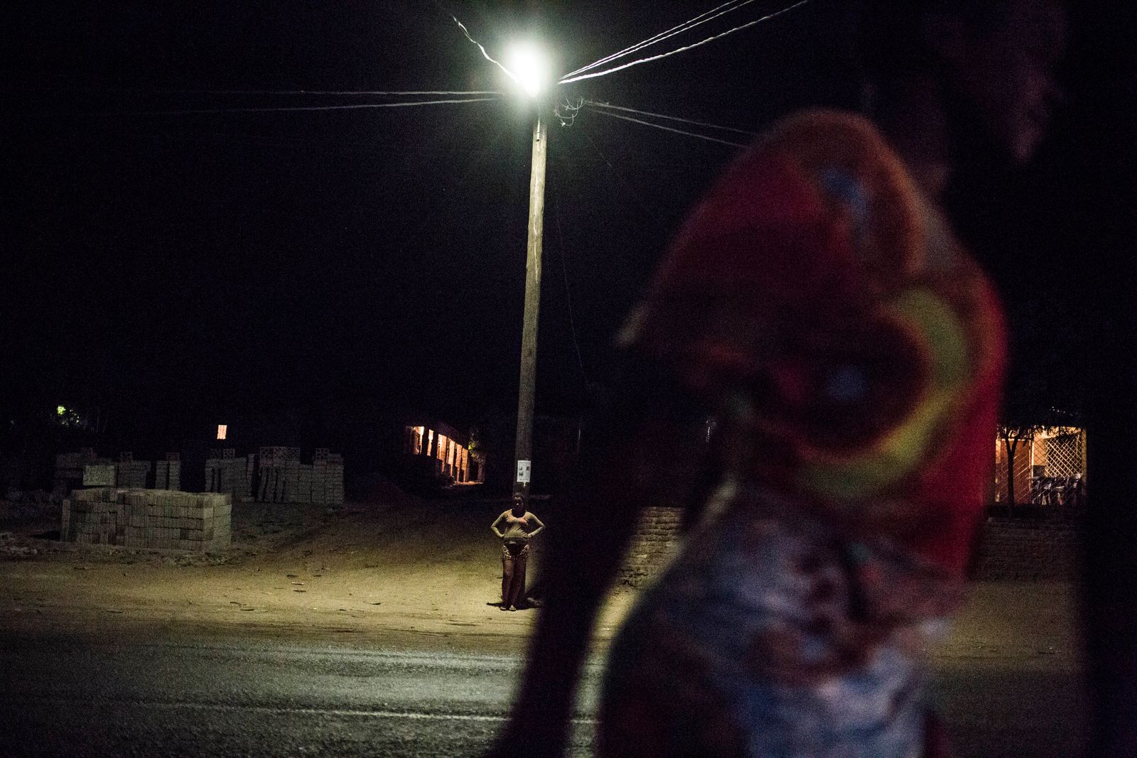 © TaraTW - A sex worker stands underneath a lamppost in Tete, Tete province, Mozambique May 11, 2018.