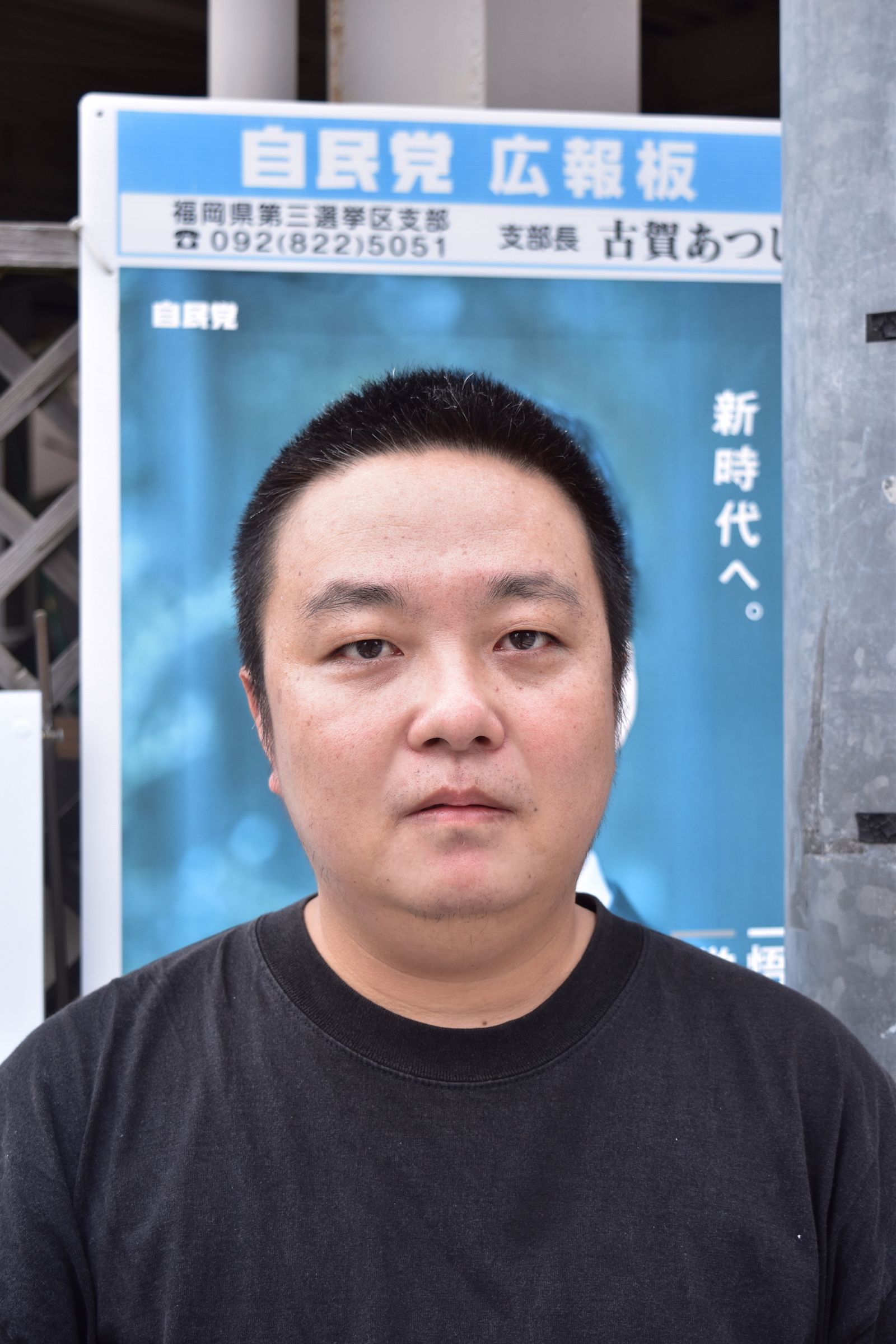 © Inokuchi Masashi - Probaganda Hero Standing in front of political advertising poster, asserting message