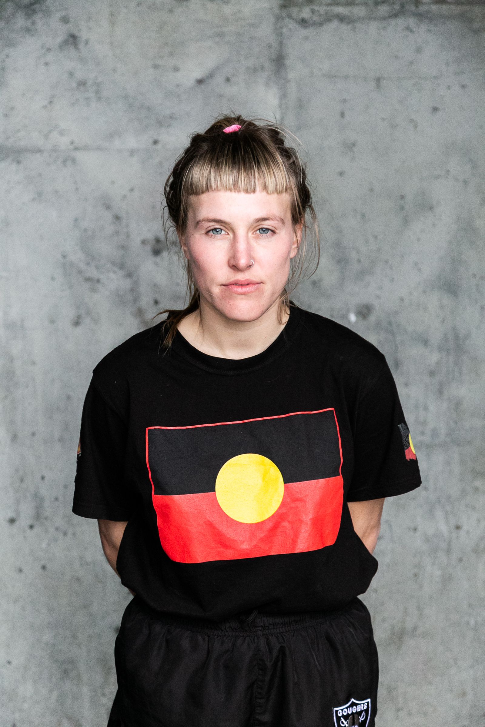 © J Forsyth - Player posed for footy card photo wearing an Indigenous flag t-shirt