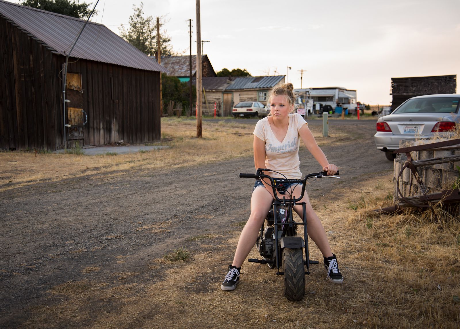 © Rosie Day - A teenage girl rides a minibike through the streets of Shaniko (Pop. 28)