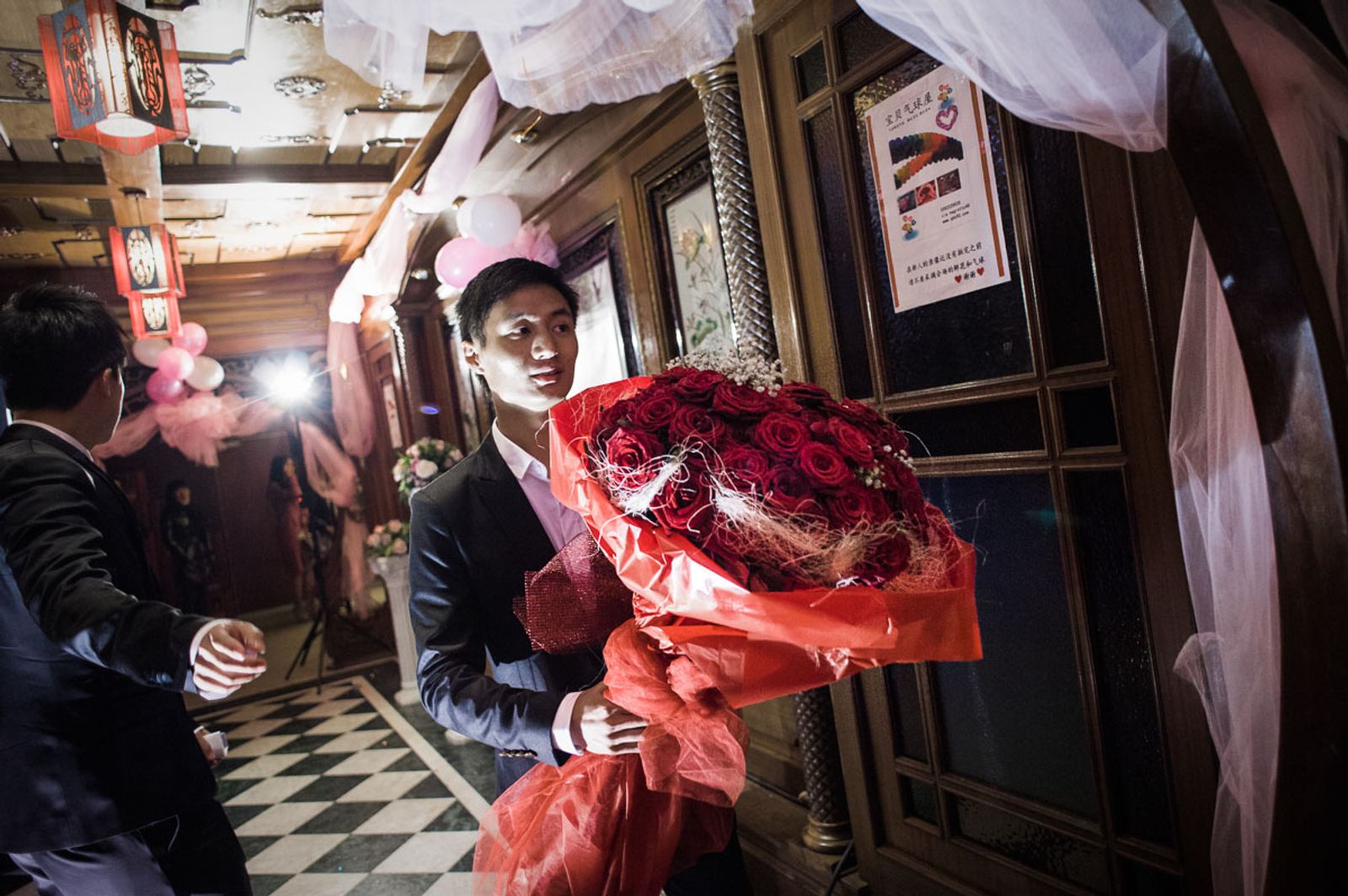 © Agnese Morganti - Prato, a big bunch of red roses is delivered for the bride to be during a Chinese engagement party