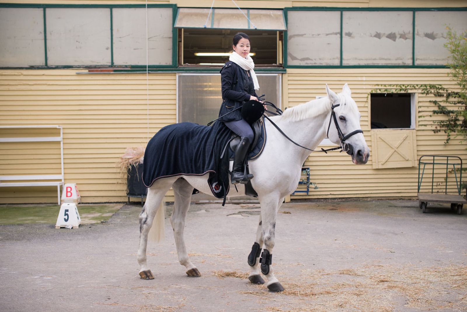 © Agnese Morganti - Florence, blogger and journalist Malia Zheng before a horse riding lesson.