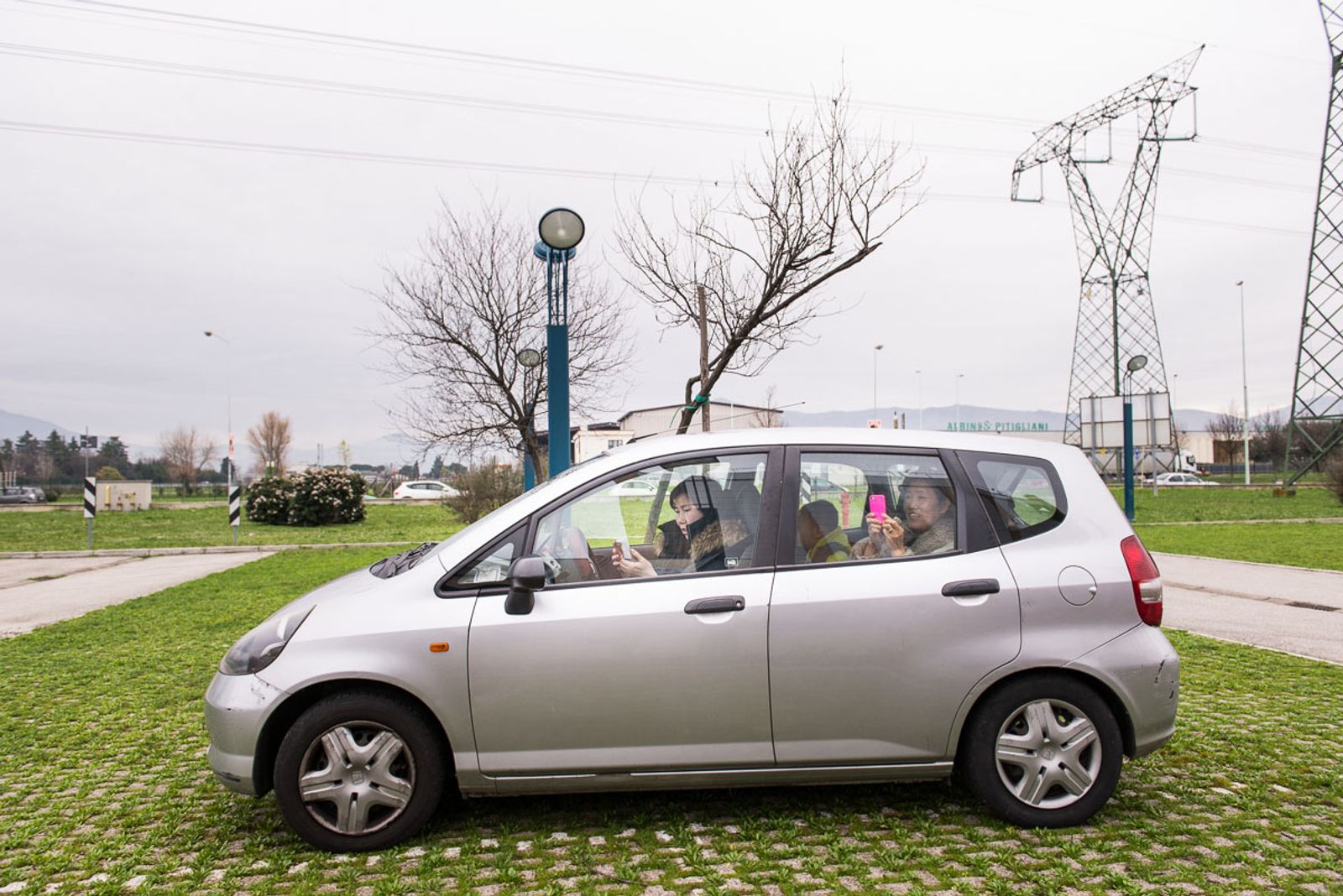 © Agnese Morganti - Prato, a family watches the Chinese New Year parade held in the industrial district from their car.