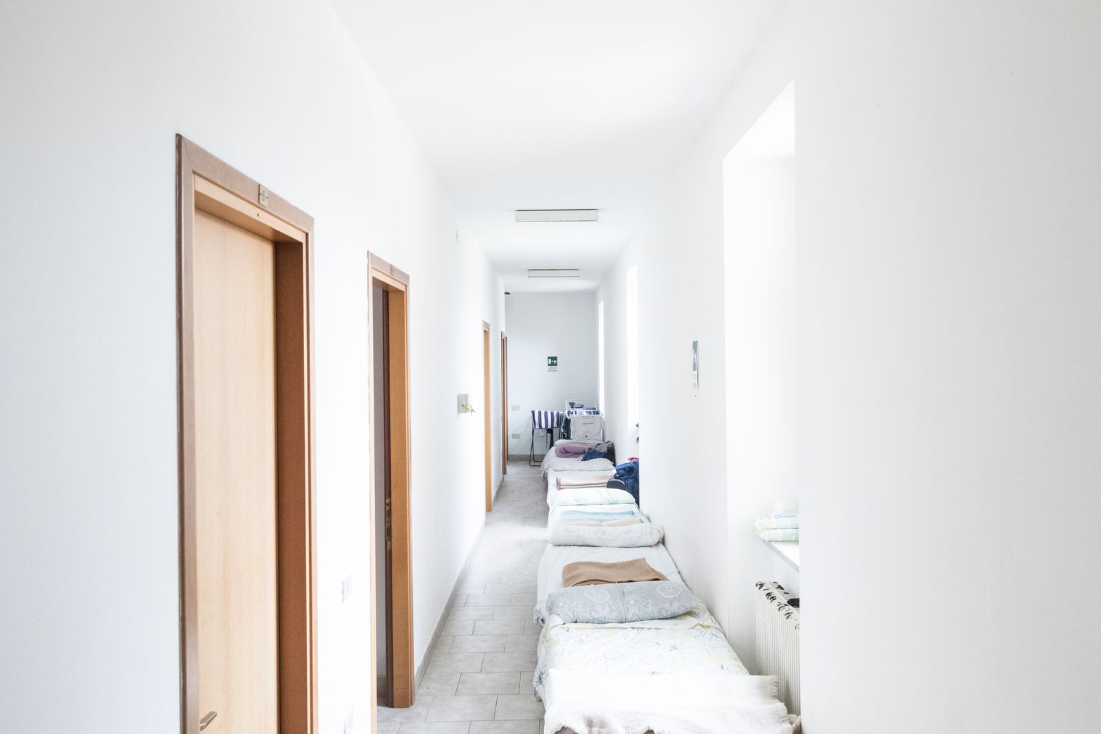 © Manuela Schirra and Fabrizio Giraldi  - Corridor used as a dormitory in the Diocesan Caritas building.