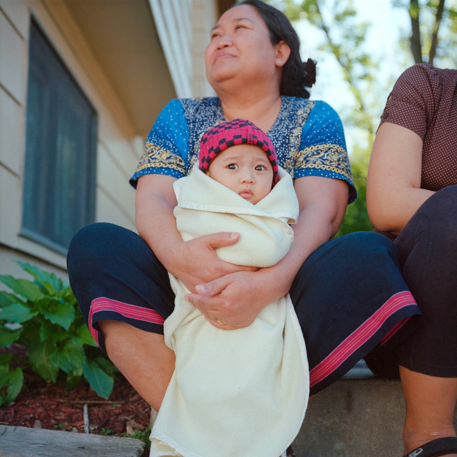 © Selma Fernandez Richter - A Karen grandmother and grandson spend time with neighbors outside on their front step.