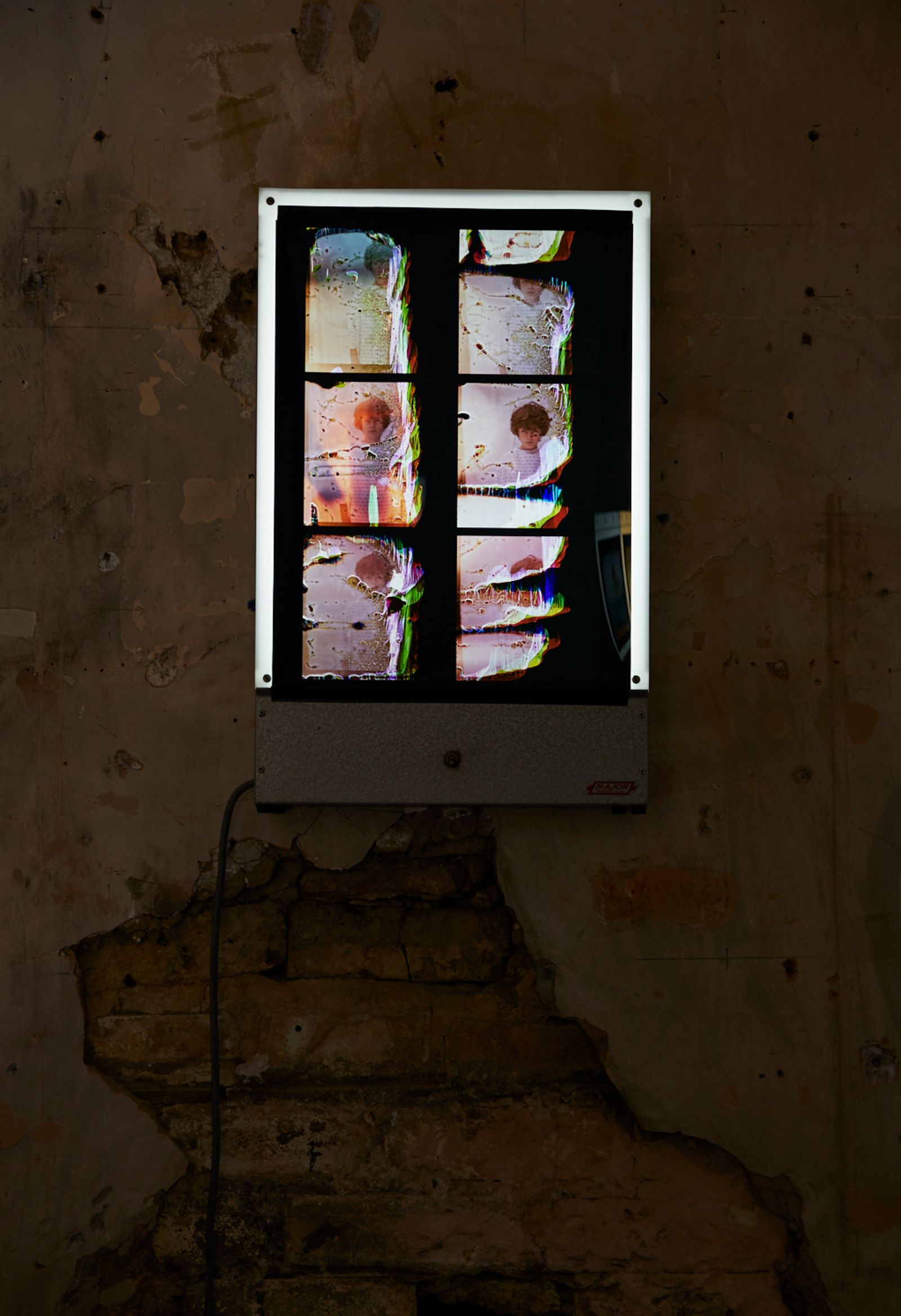 © Rhiannon Adam - Installation shot. View of Duratrans contact sheet of Noah's film roll displayed on reclaimed hospital x-ray viewer