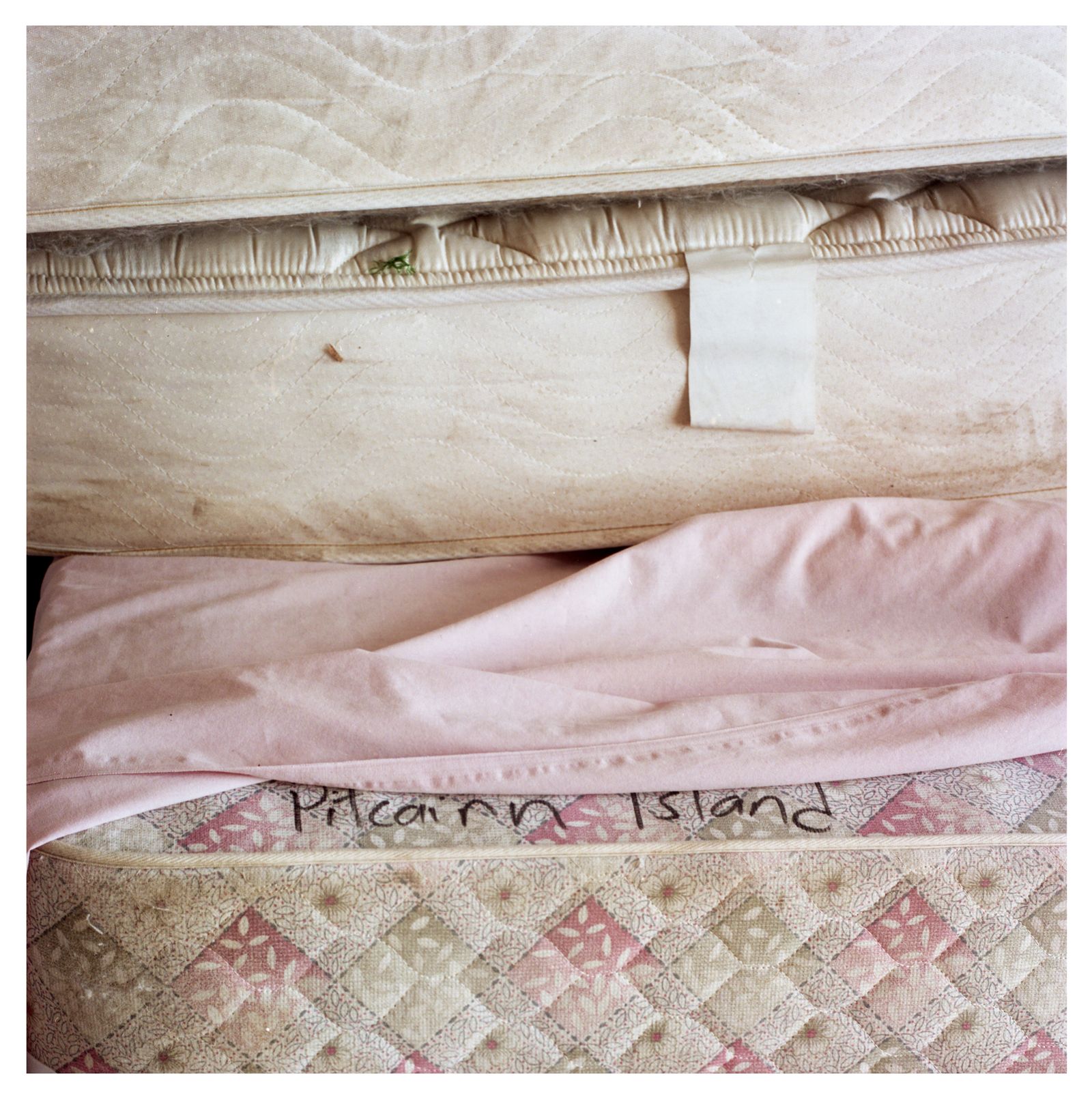 © Rhiannon Adam - Mattresses on Pitcairn, stacked in the childhood bedroom of a girl that has long since left.