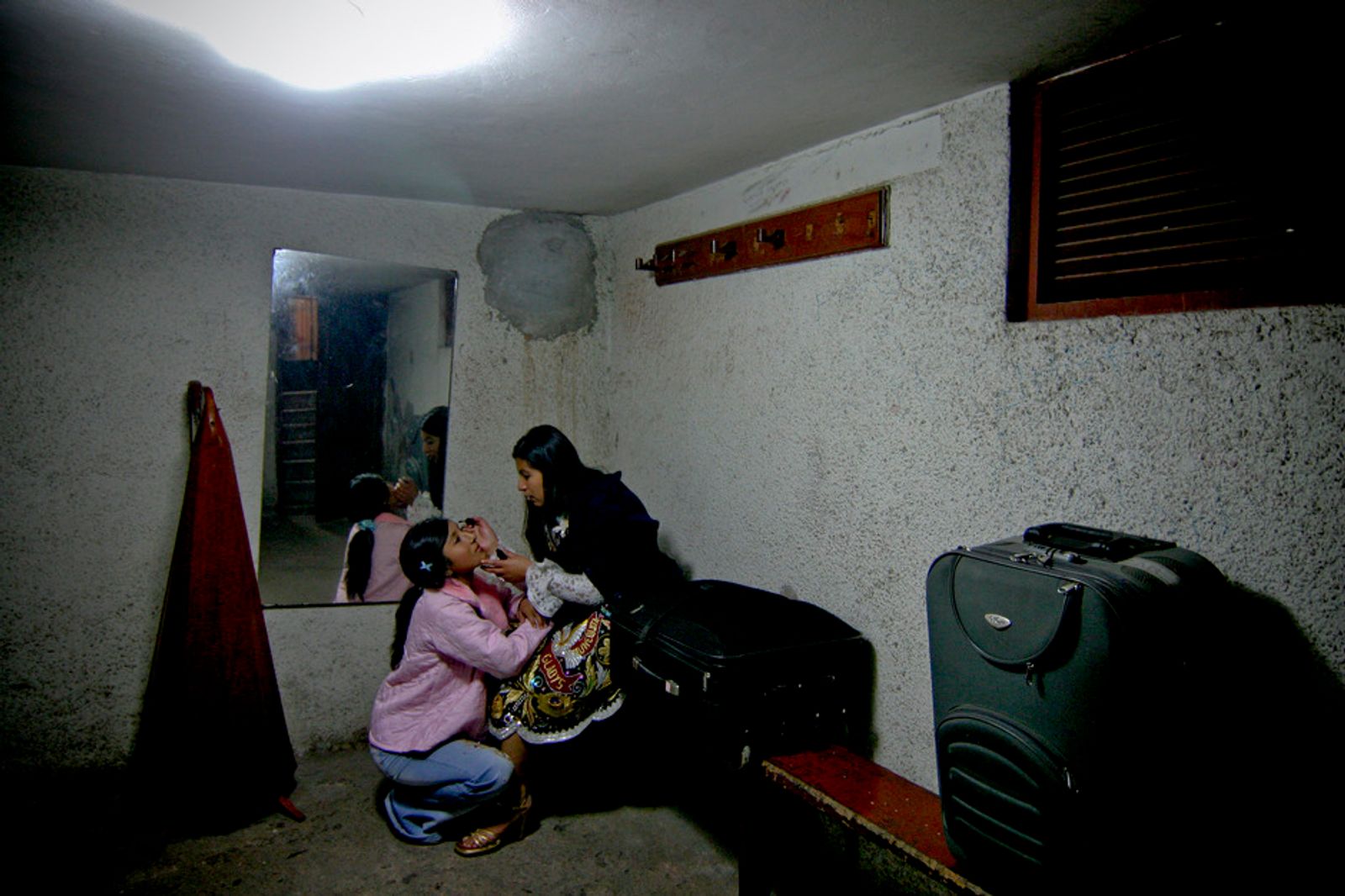 © Max Cabello Orcasitas - Dressing singing. Yanet Acuña is helped to make up by a friend also singer.