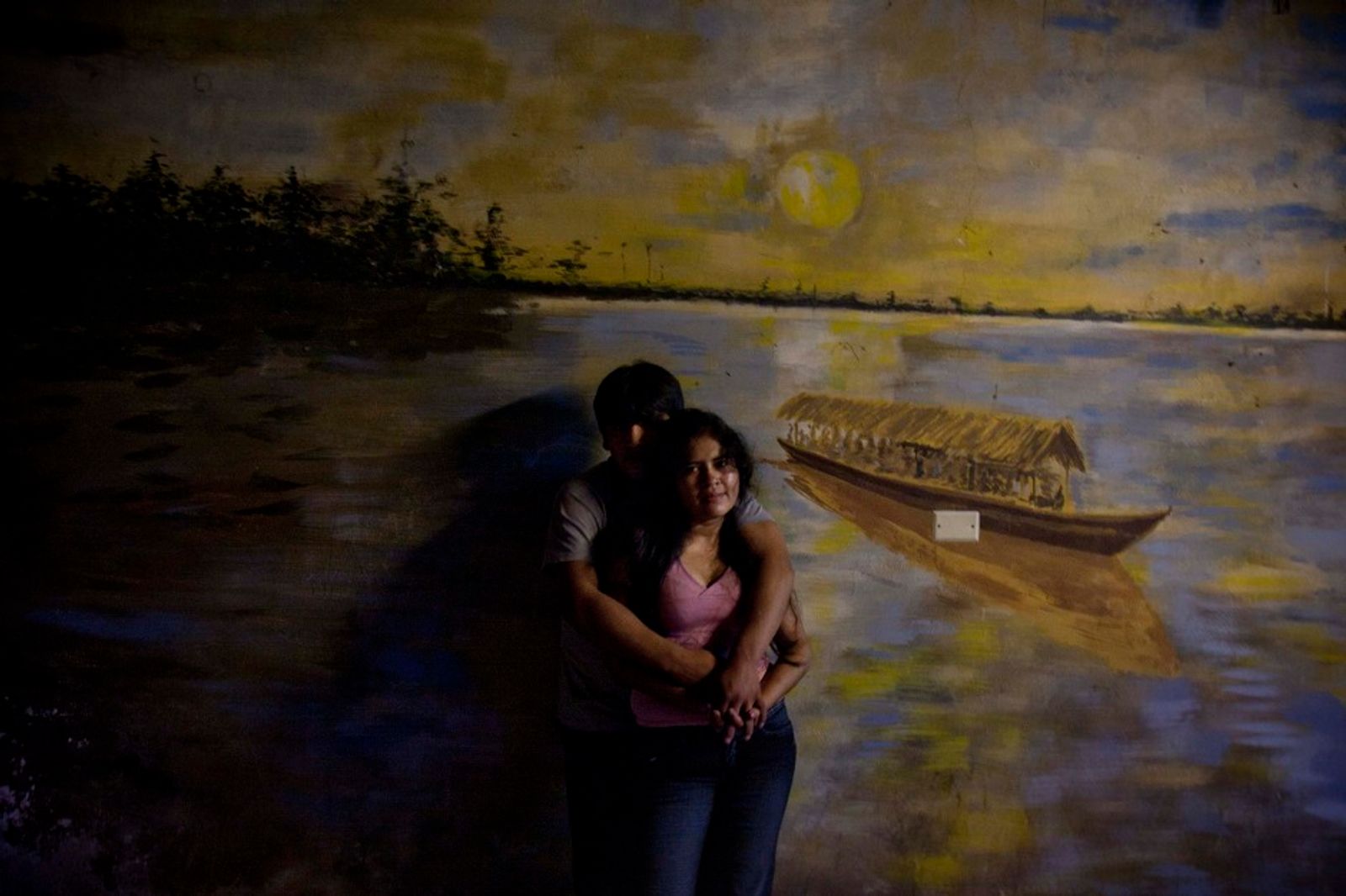 © Max Cabello Orcasitas - A couple embrace as they watch the show for a birthday party at a restaurant in the northern outskirts of Lima.