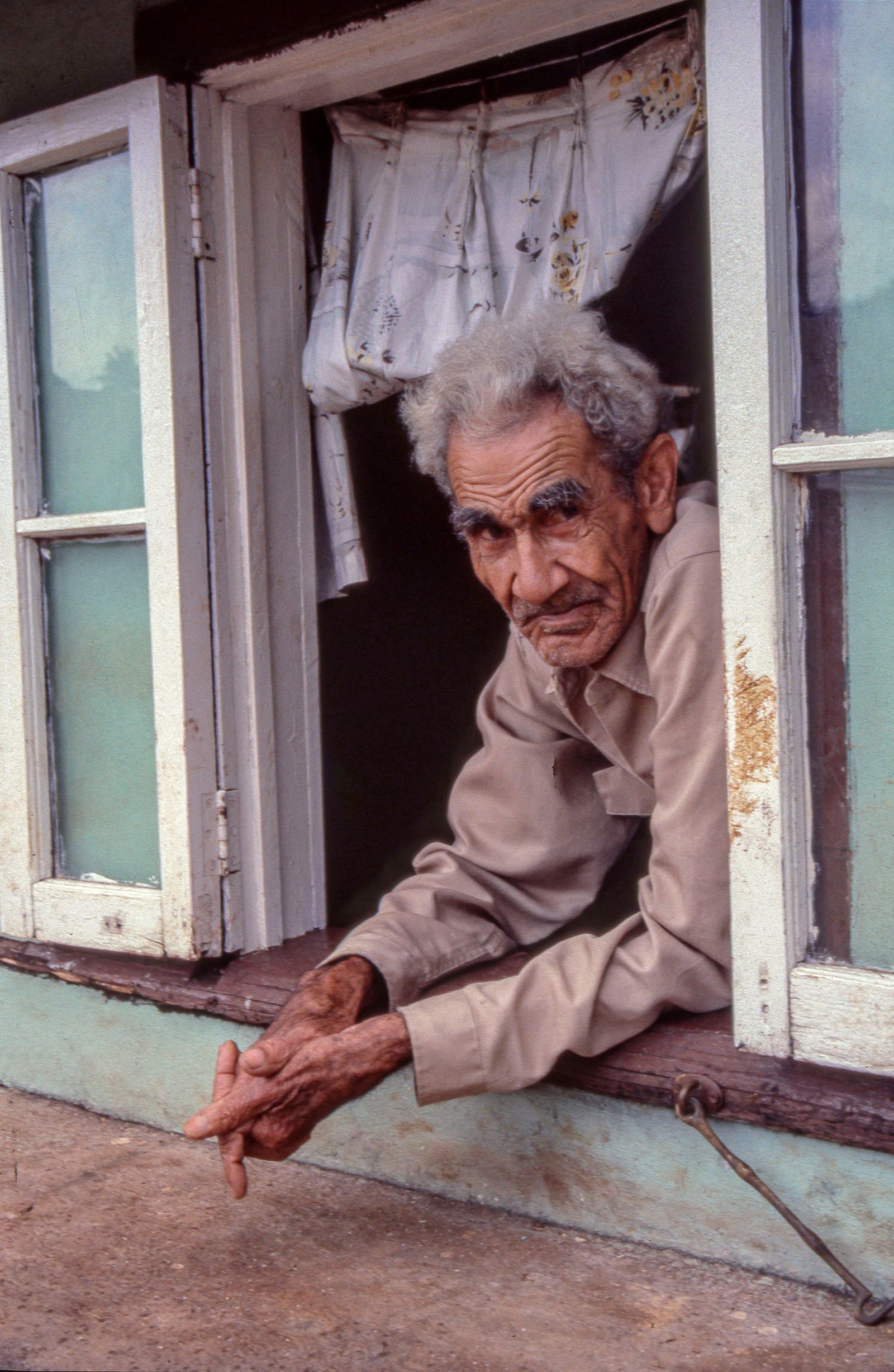 © Steven Edson - Old man looking out of the window of his home. Ocho Rios, Jamaica