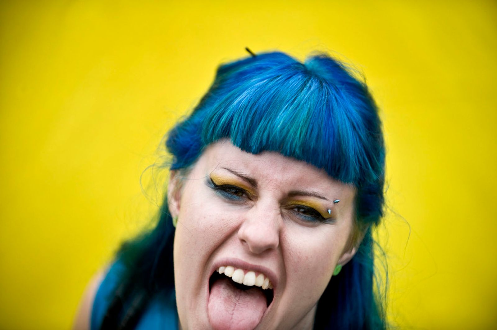© Steven Edson - Woman with blue hair against yellow wall. Mansfield, MA