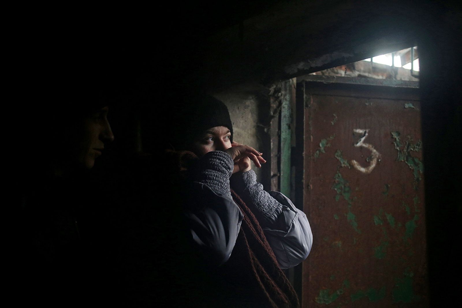 © Anastasia  Vlasova - A woman and a man hide in a basement during the shelling of Debaltseve, Donetsk area, Ukraine.