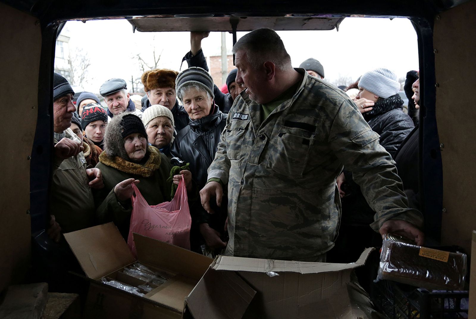 © Anastasia  Vlasova - Local residents of Popasna village, Luhansk area stand in a line to receive the humanitarian aid.