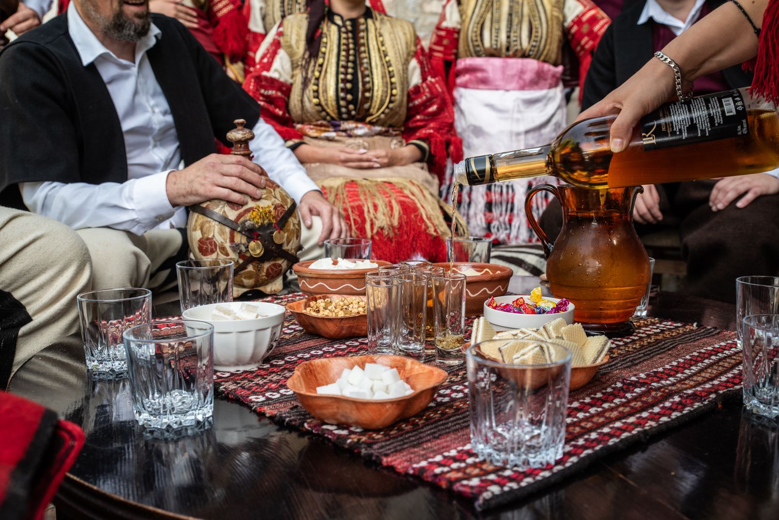 © Biljana Jurukovski - In the Godfathers house, where the groom and his best man and family are served some food and local rakija