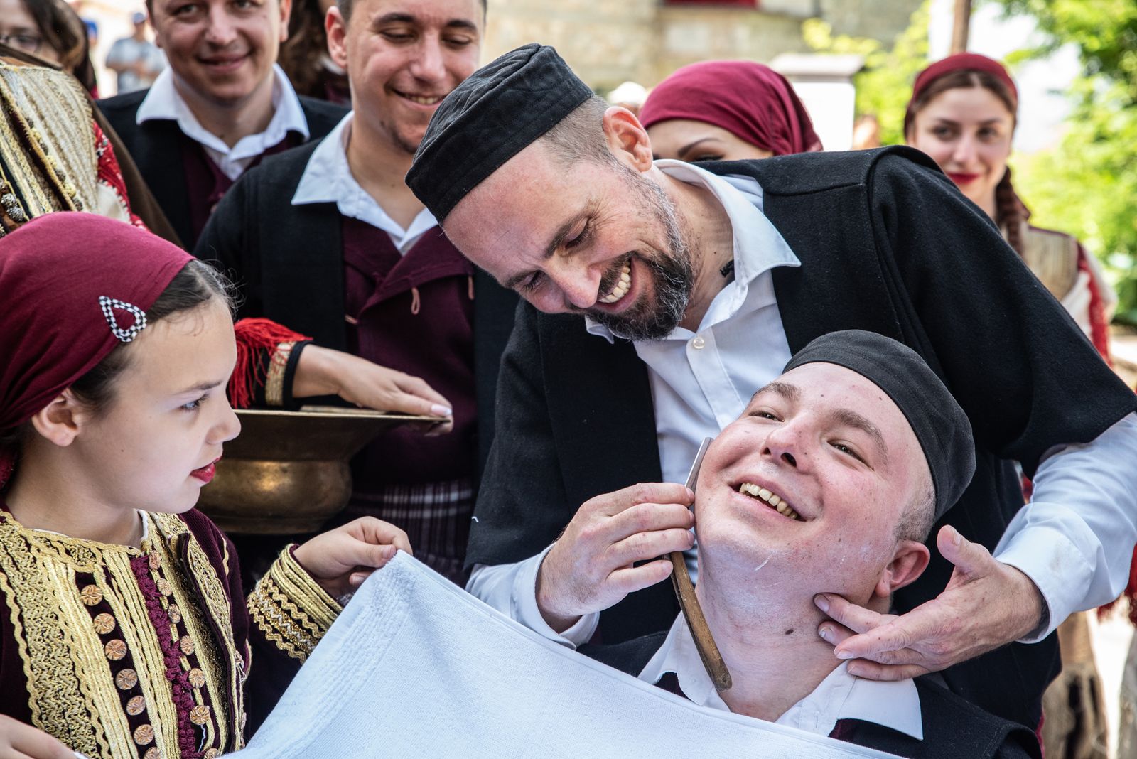 © Biljana Jurukovski - As part of the tradition is the best man to shave the groom in the middle of the village