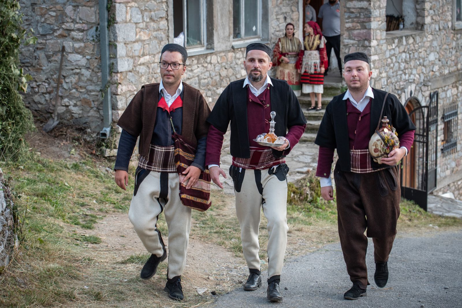 © Biljana Jurukovski - The groom and the best man "dever" take rakija and are on the way to invite the Godfather in a traditional way