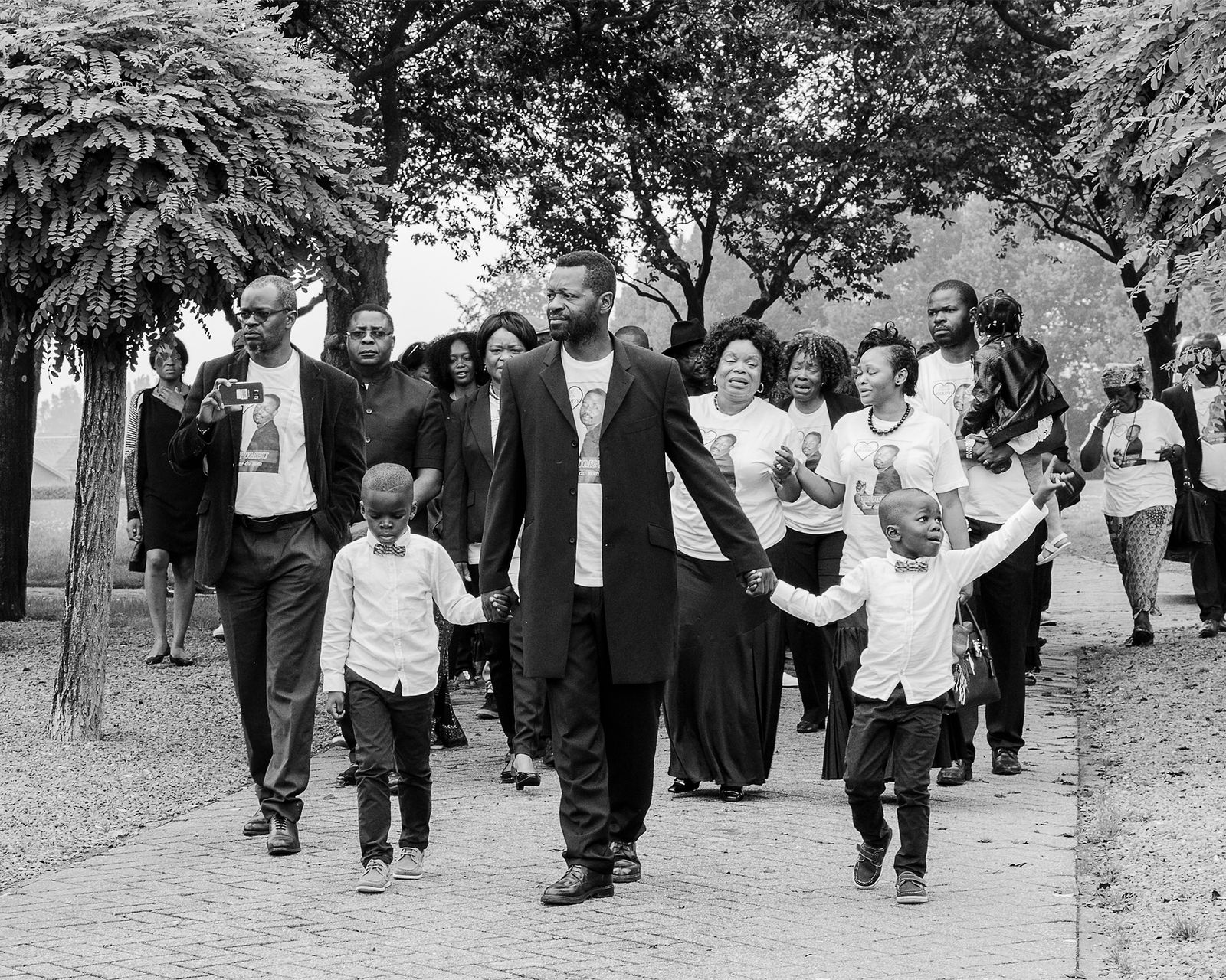 © Rebecca  Fertinel - Family are leading the people to the graveyard. In front the kids and brother of the deceased one.