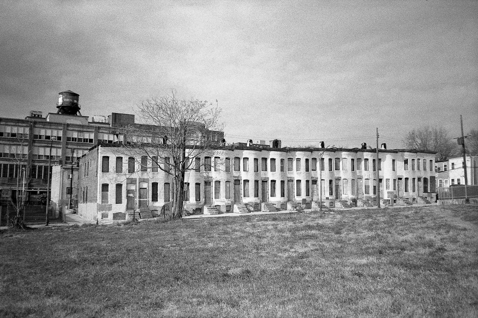 © John Perivolaris - Boarded Up Rowhouses, Border of Greenmount West and Oliver, Baltimore, 2009.