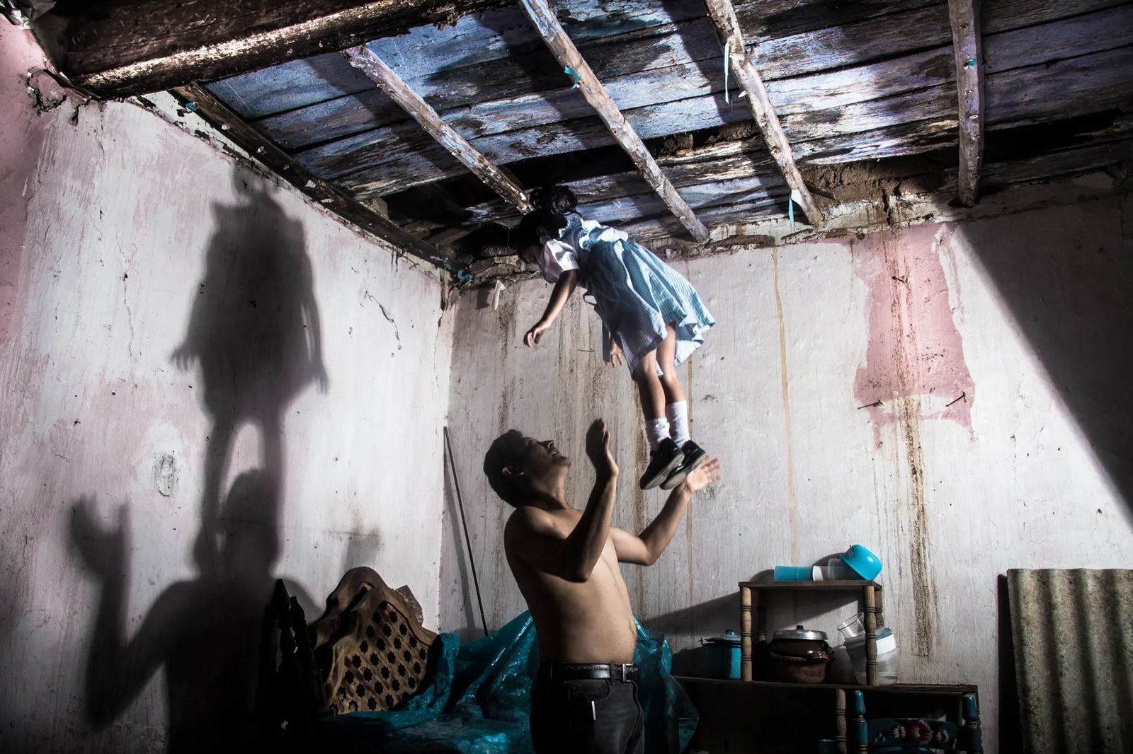 © Yael Martínez - The house that bleeds (self portrait with my daughter and apresence of a hanging man) Guerrero Mexico