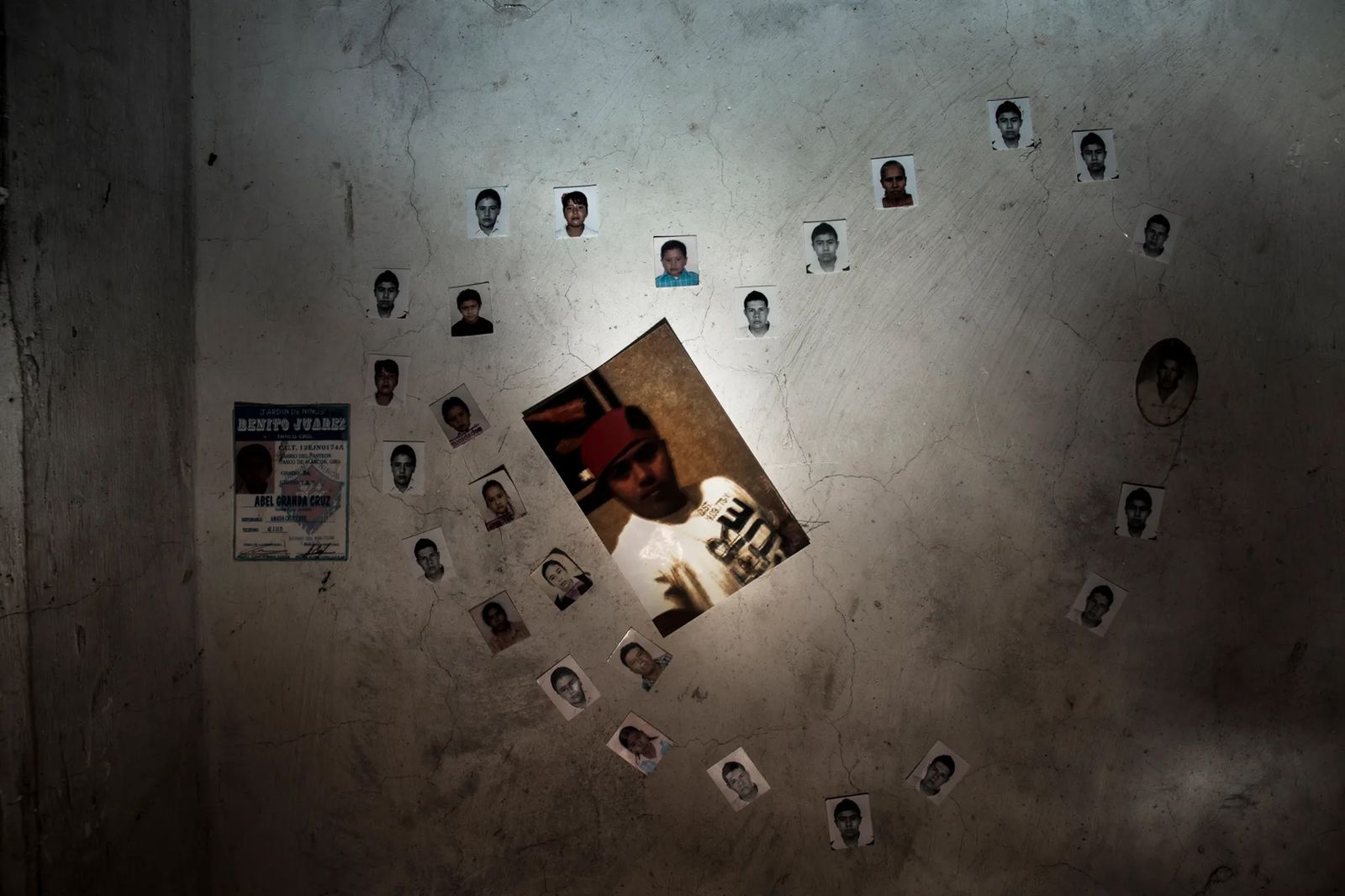 © Yael Martínez - Family heart. Photos on the wall of Perla Granda's bedroom of her missing