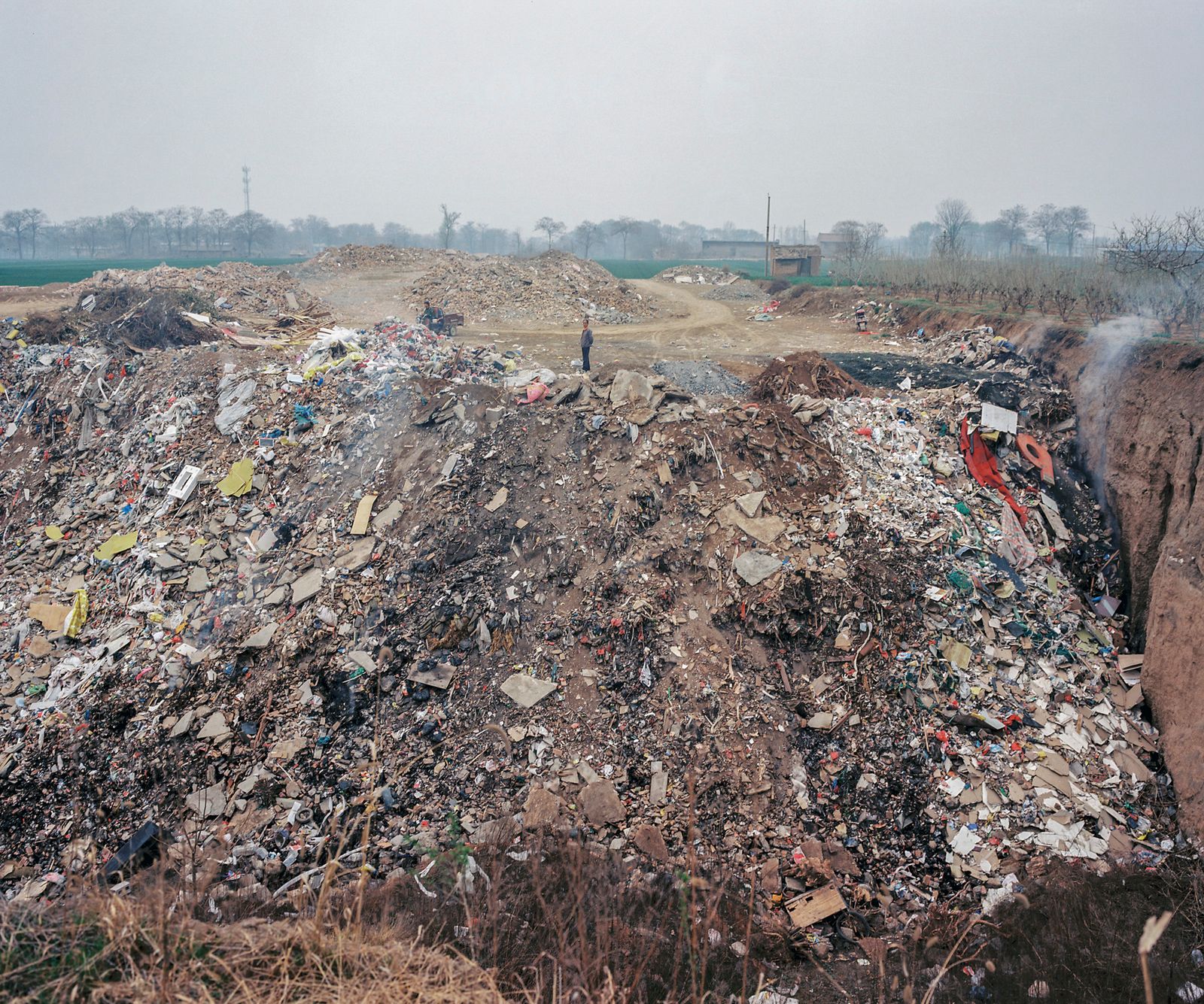 © Pan Wang - 20.The soil is refilled as construction waste into large pits dug by the brick factory