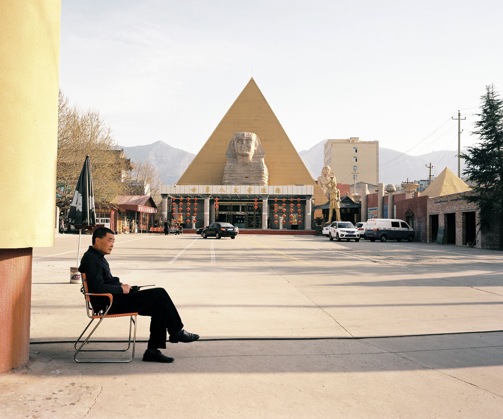 © Pan Wang - 14. A parking lot administrator with nothing to do at the entrance of an artificial tourist attraction