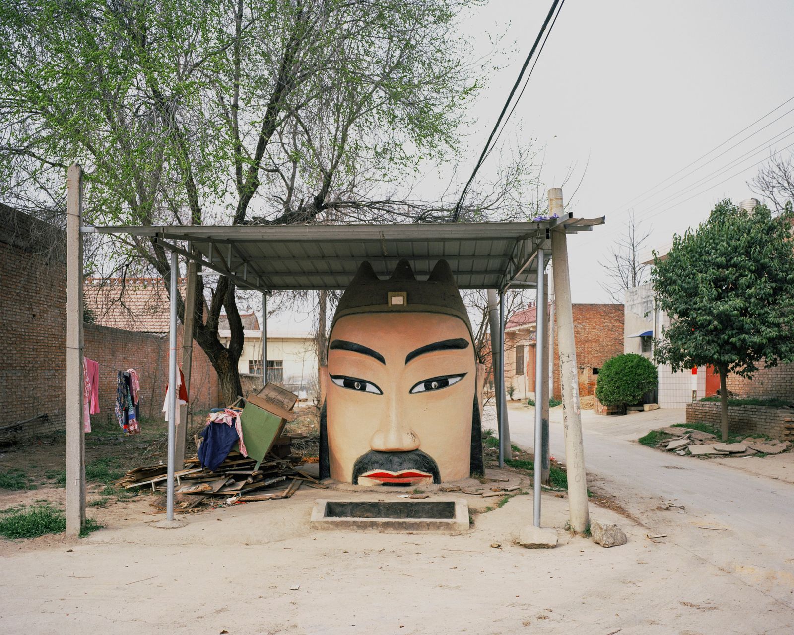 © Pan Wang - 18.In the temple in the village, there is a big headed Buddha statue