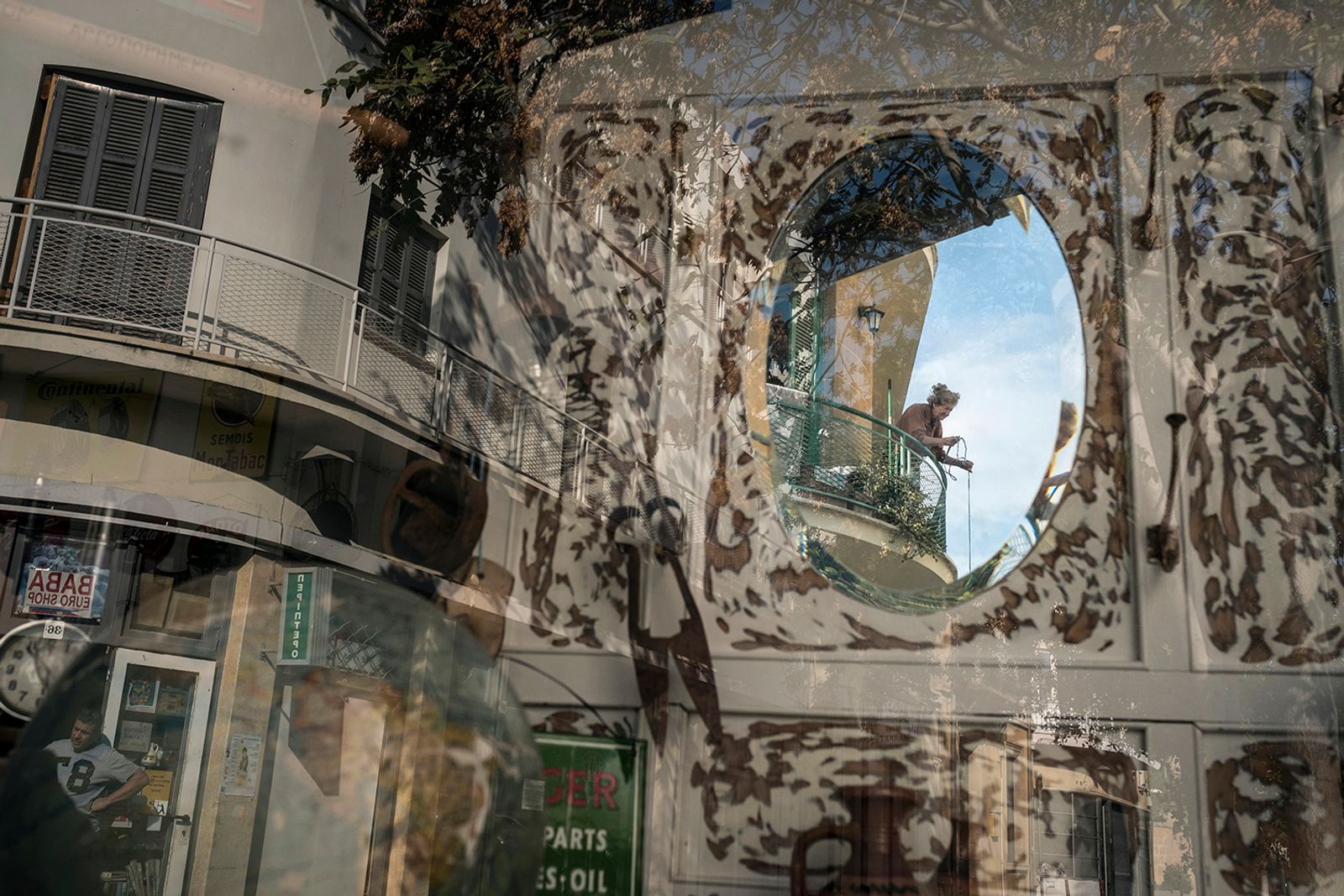 © Sahan Nuhoglu - An old Greek Cypriot woman is reflected on a retro decoration shop window based in Nicosia, Cyprus.