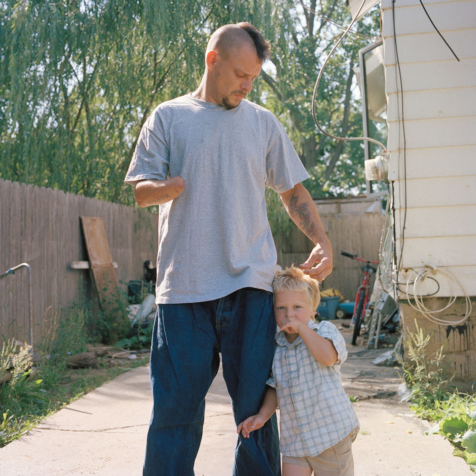 © Juan Madrid - Nubbz and his son. Nubbz lost hand and forearm saving his daughter from a firework.