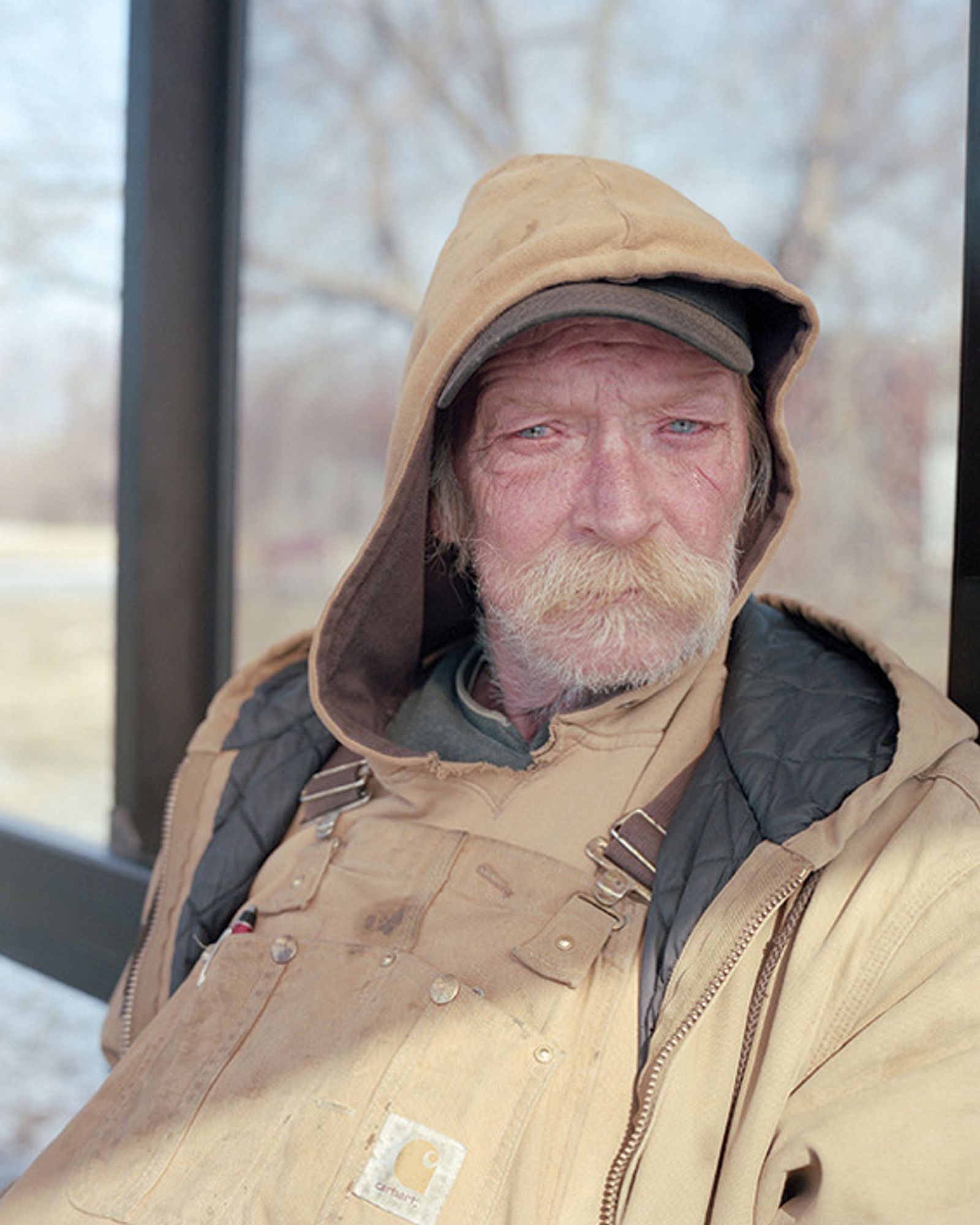 © Juan Madrid - Steve at a bus stop. He works as a laborer and has lived 40 years in Flint.